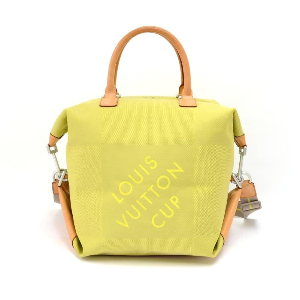 Louis Vuitton limited edition lime Damier Geant canvas boston bag from the 2003 LV Cup. Outside has a silver-tone hardware with cowhide leather handles and bottom. Inside has gray lining with 1 open pocket. Comfortably carried in hand or on the