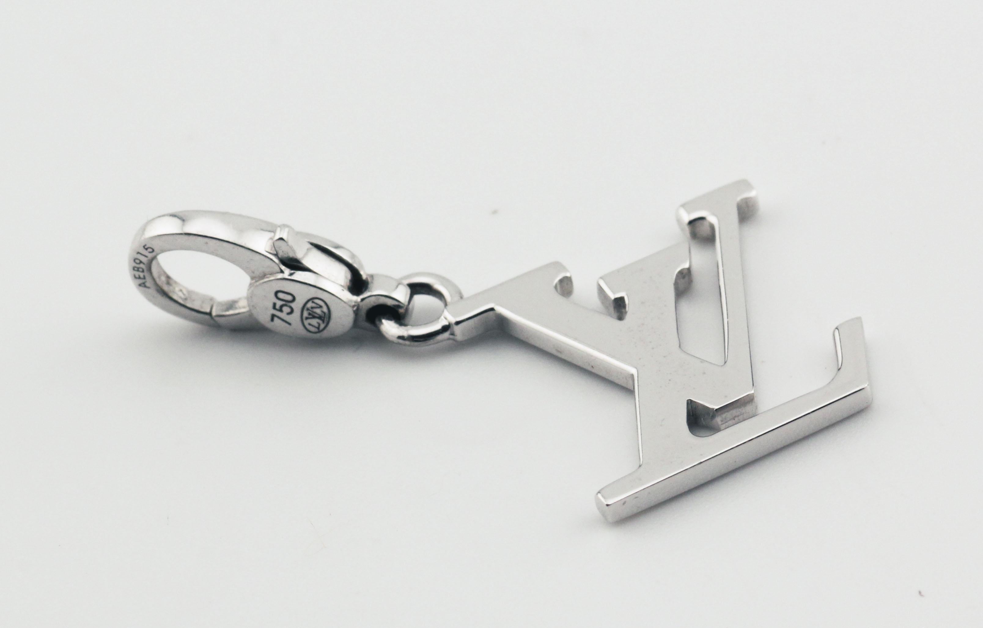 The Louis Vuitton LV Logo 18k White Gold Charm Pendant is a luxurious and iconic accessory that perfectly embodies the elegance and sophistication of the Louis Vuitton brand. Crafted from exquisite 18k white gold, this charm pendant features the