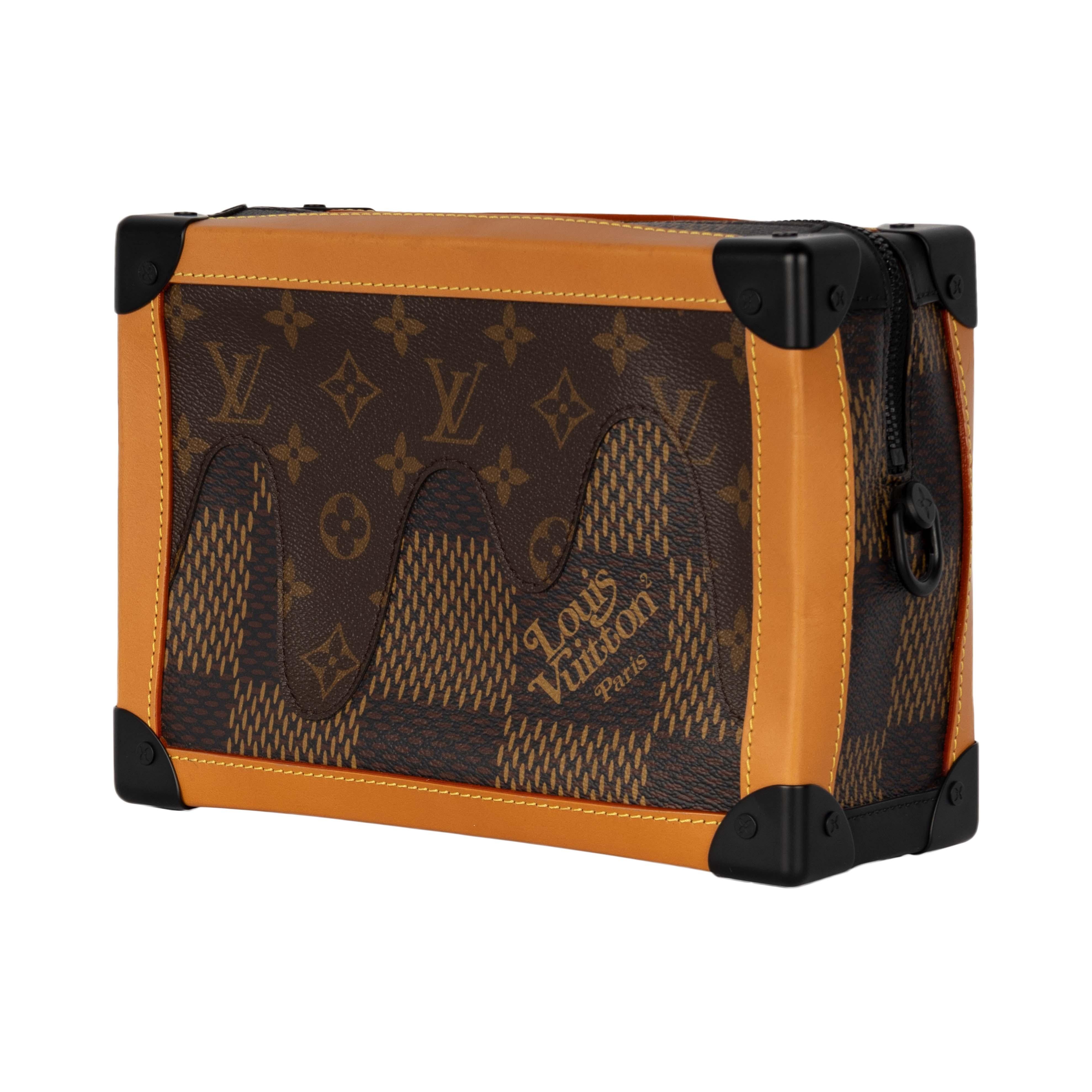 A unique collaboration between two historical brands with distinct cultural roots, this Louis Vuitton x Soft Mini Trunk adapts to the unique vision of merging two different fashion approaches. The messenger bag in the Giant Damier Ebene leather is