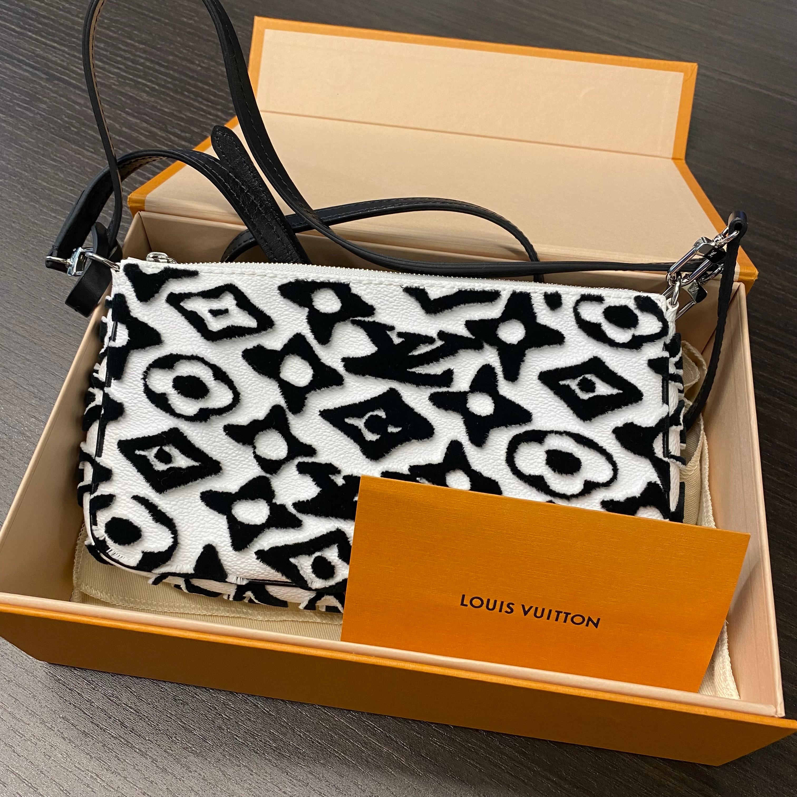 This special edition Louis Vuitton Pochette Accessoires handbag is arrayed in the arty new version of Monogram, reimagined by Urs Fischer for the exclusive LV x UF collection. The velvety tufted motif gives the bag a unique tactile appeal, whether