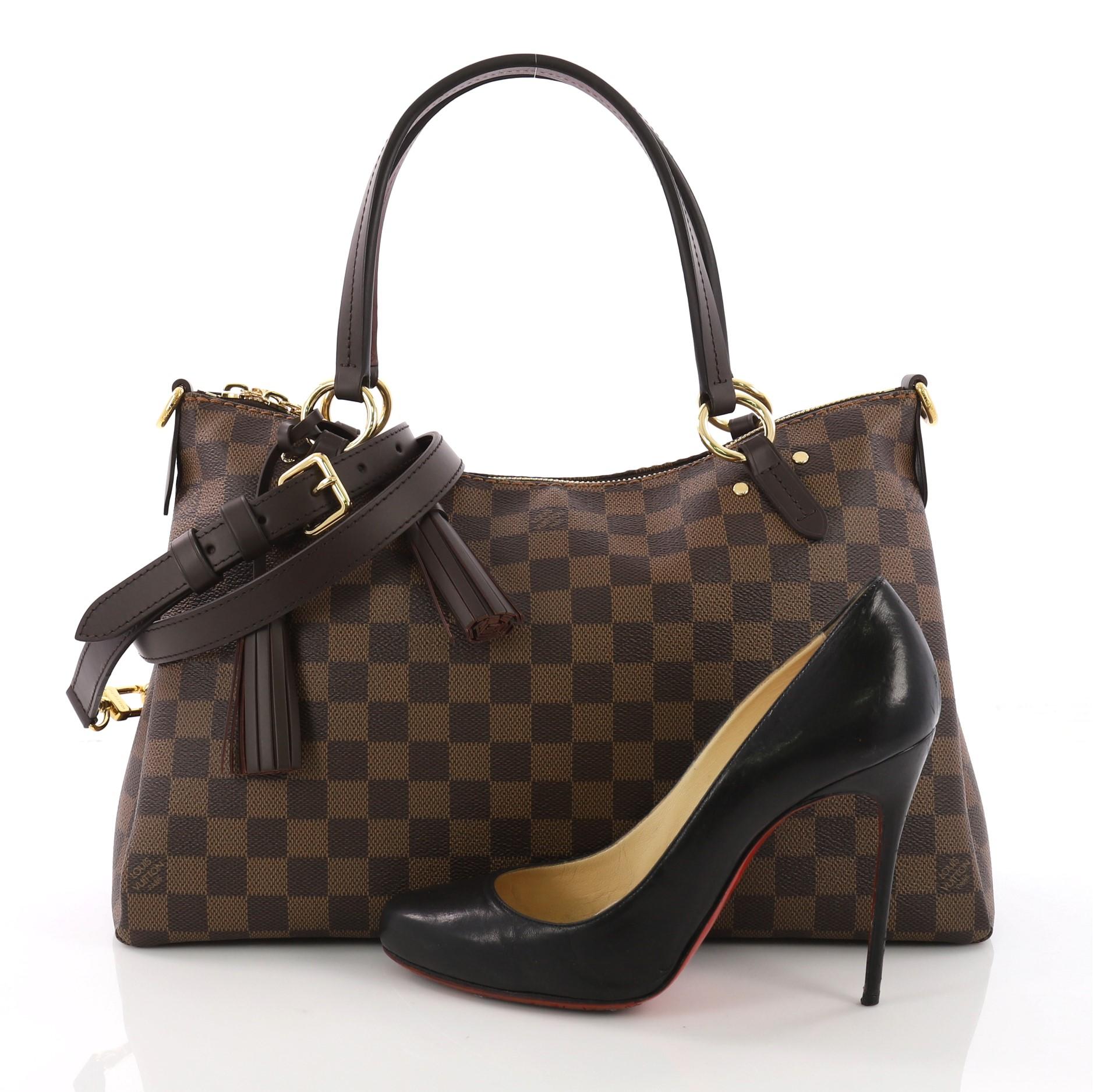 This Louis Vuitton Lymington Handbag Damier, crafted from damier ebene coated canvas, features dual flat handles, tassels, and gold-tone hardware. Its zip closure opens to a brown fabric interior with slip pocket. Authenticity code reads: CA0158.
