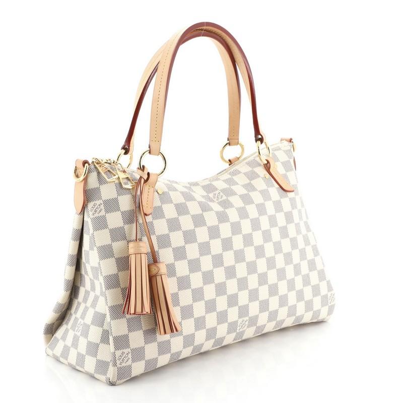This Louis Vuitton Lymington Handbag Damier, crafted from damier azur coated canvas, features dual flat handles, leather tassels, and gold-tone hardware. Its zip closure opens to a pink fabric interior with slip pocket. Authenticity code reads: