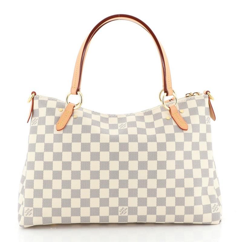 This Louis Vuitton Lymington Handbag Damier, crafted from damier azur coated canvas, features dual flat handles, leather tassels, and gold-tone hardware. Its zip closure opens to a pink fabric interior with slip pocket. Authenticity code reads: