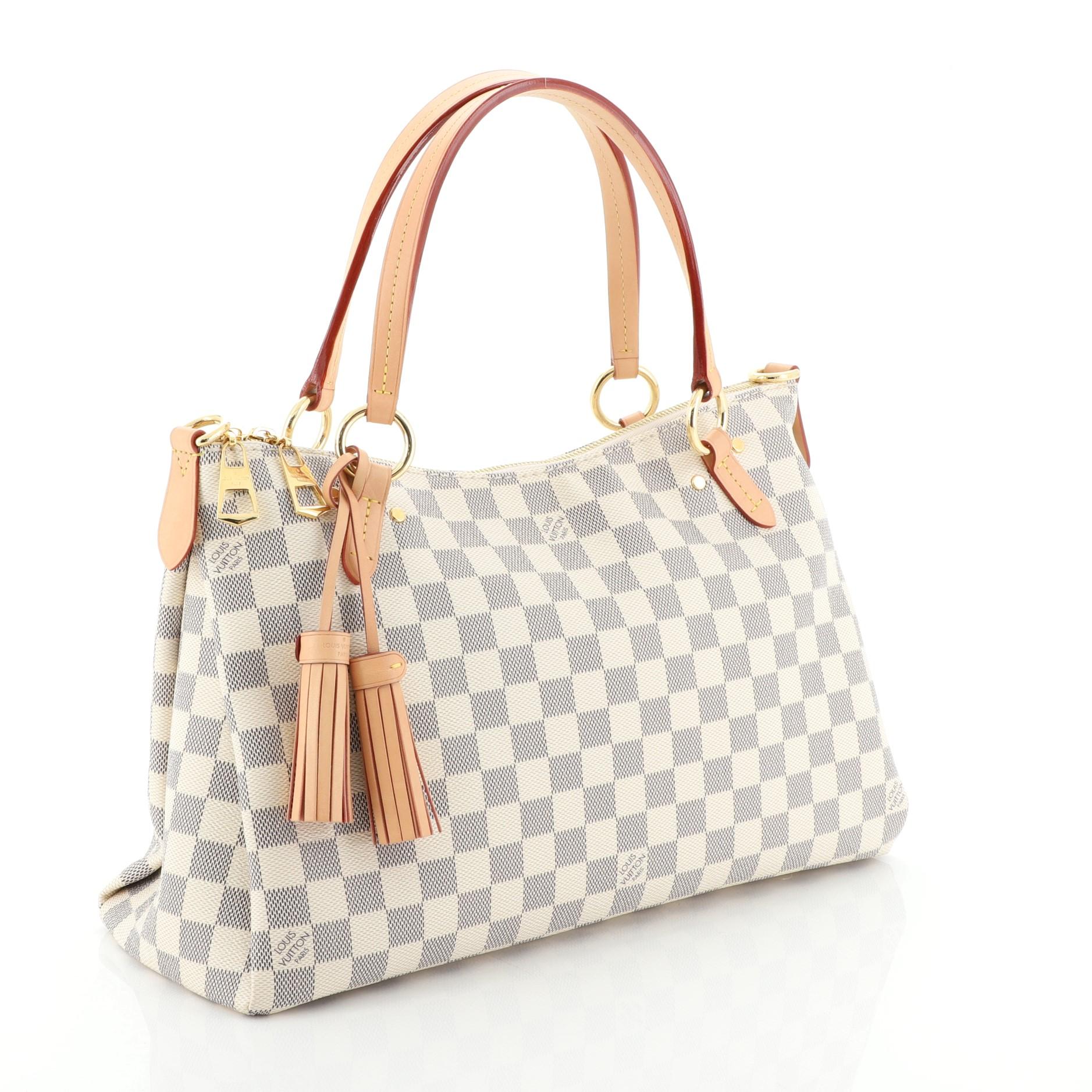 This Louis Vuitton Lymington Handbag Damier, crafted from damier azur coated canvas, features dual flat handles, leather tassels, and gold-tone hardware. Its zip closure opens to a pink fabric interior with slip pocket. Authenticity code reads: