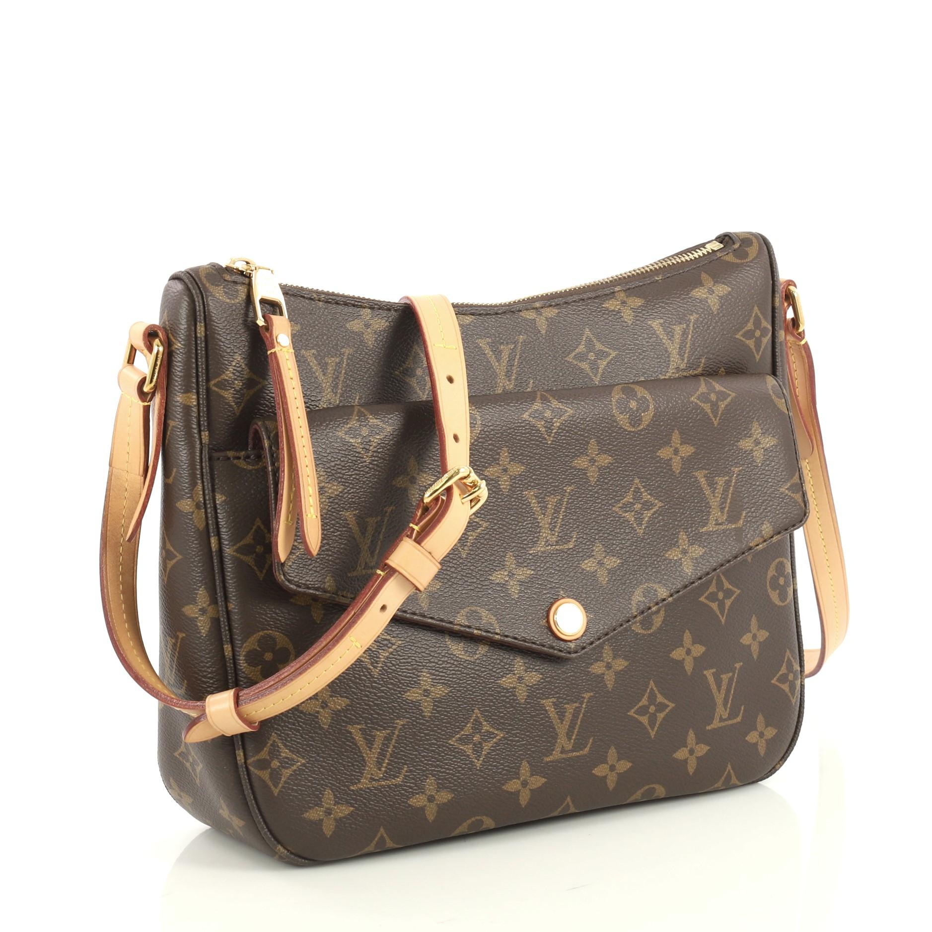 This Louis Vuitton Mabillon Shoulder Bag Monogram Canvas, crafted from brown monogram canvas, features an adjustable natural cowhide leather strap, exterior front snap pocket, and gold-tone hardware. Its zip closure opens to a red fabric interior.