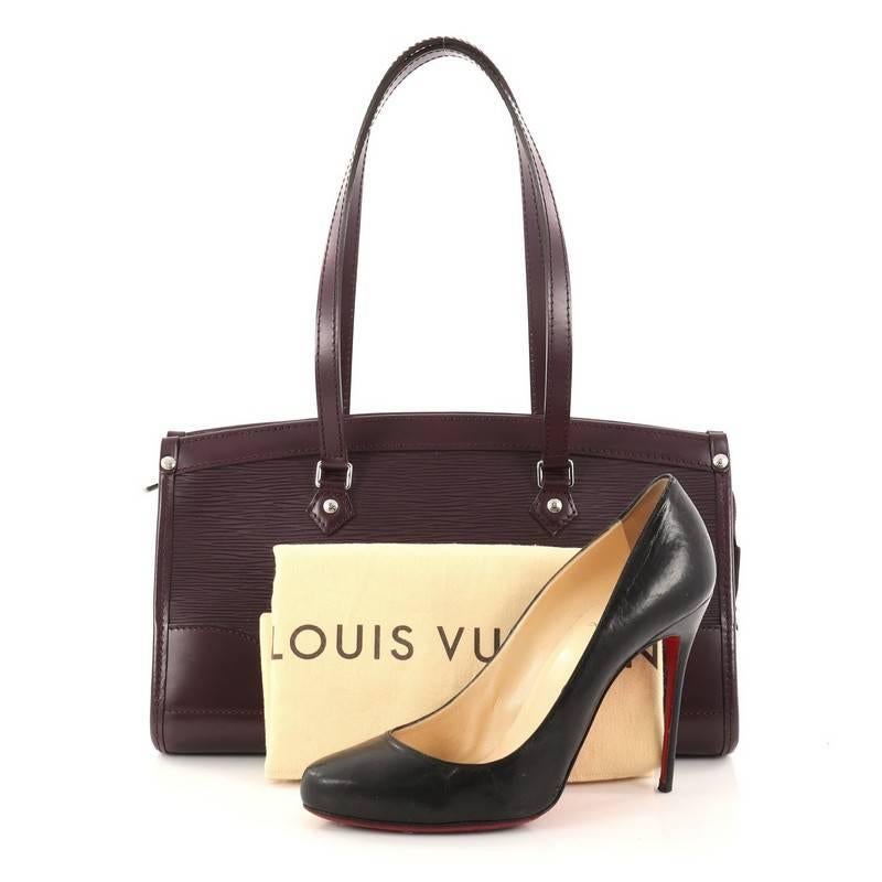 This authentic Louis Vuitton Madeleine Handbag Epi Leather PM named after the Parisian church Place de la Madeleine is a perfectly elegant bag for day or night. Crafted from purple epi leather, this chic tote features dual-flat leather handles and