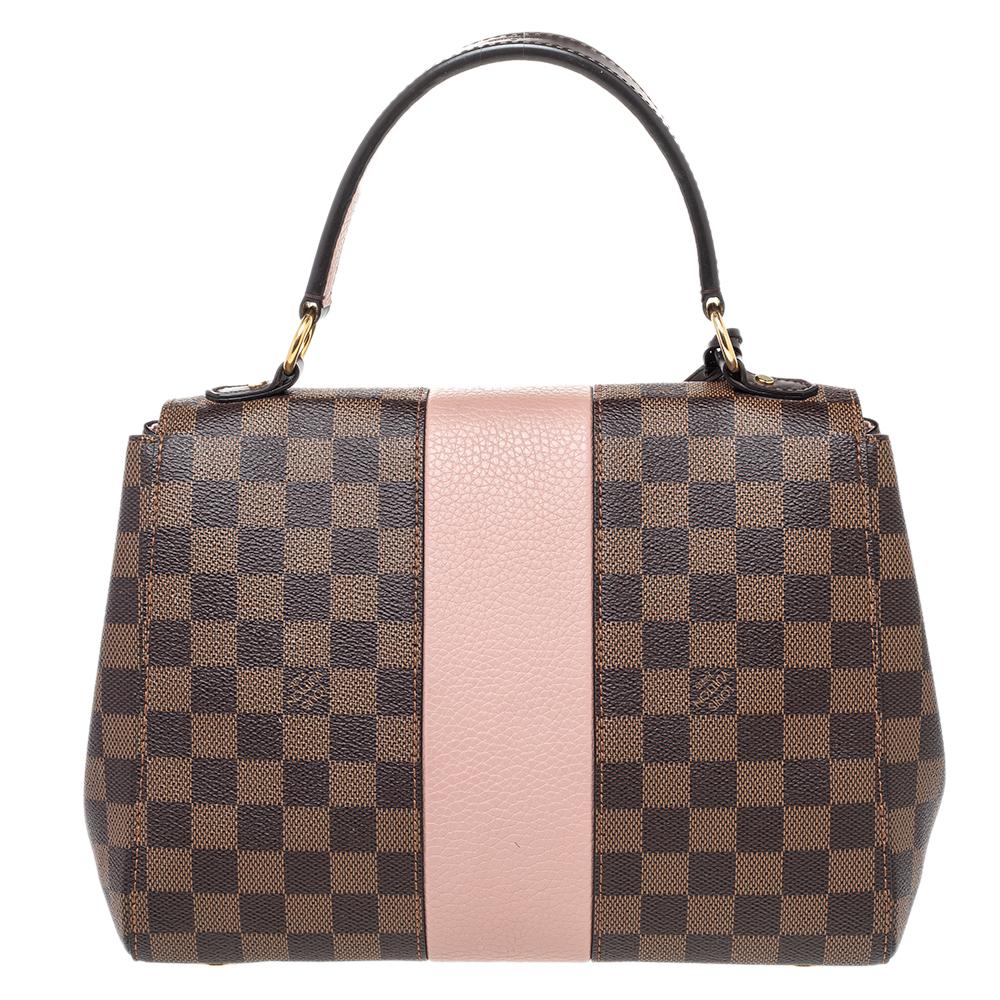 This stylish and chic Bond Street bag by Louis Vuitton comes in a lovely color palette. It has been crafted from the brand's signature Damier Ebene canvas and leather. Flawlessly functional, it is the perfect companion for day and night outings. It