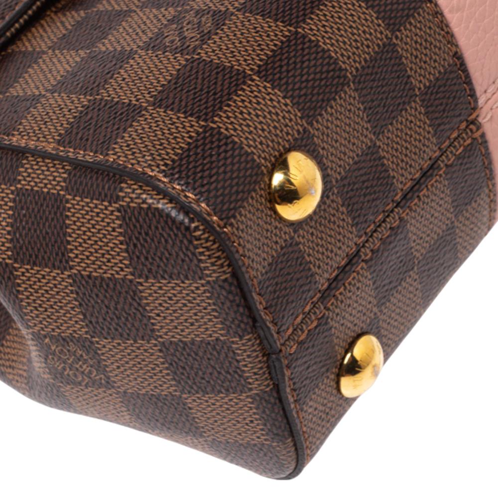 This stylish and chic Bond Street bag by Louis Vuitton comes in a lovely color palette. It has been crafted from the brand's signature Damier Ebene canvas and pink leather. Flawlessly functional, it is the perfect companion for day and night