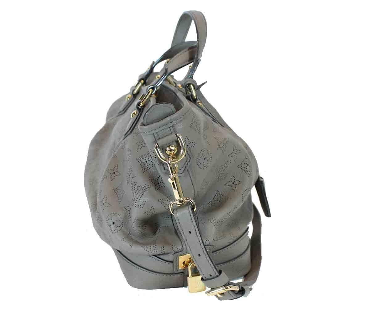 Powder gray leather. Gold-tone hardware. Top zippered closure. Dual top handles. Removable shoulder strap. One large interior zippered pocket. Two interior opened pockets.