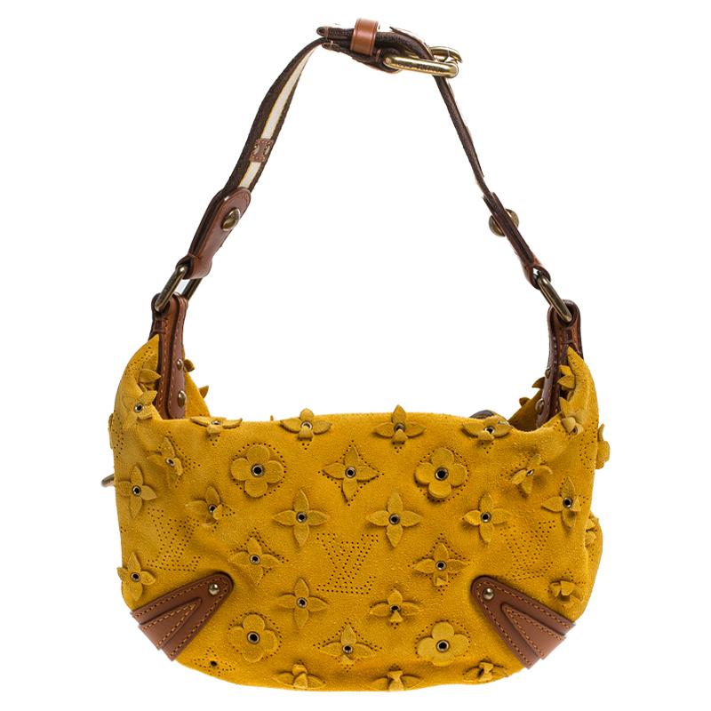 This stunning Louis Vuitton Onatah Fleurs PM bag is a rare find. Part of a limited edition line from the fashion house, this bag has been crafted from Mais monogram suede and finished with leather trims. It is secured with a top zipper closure and