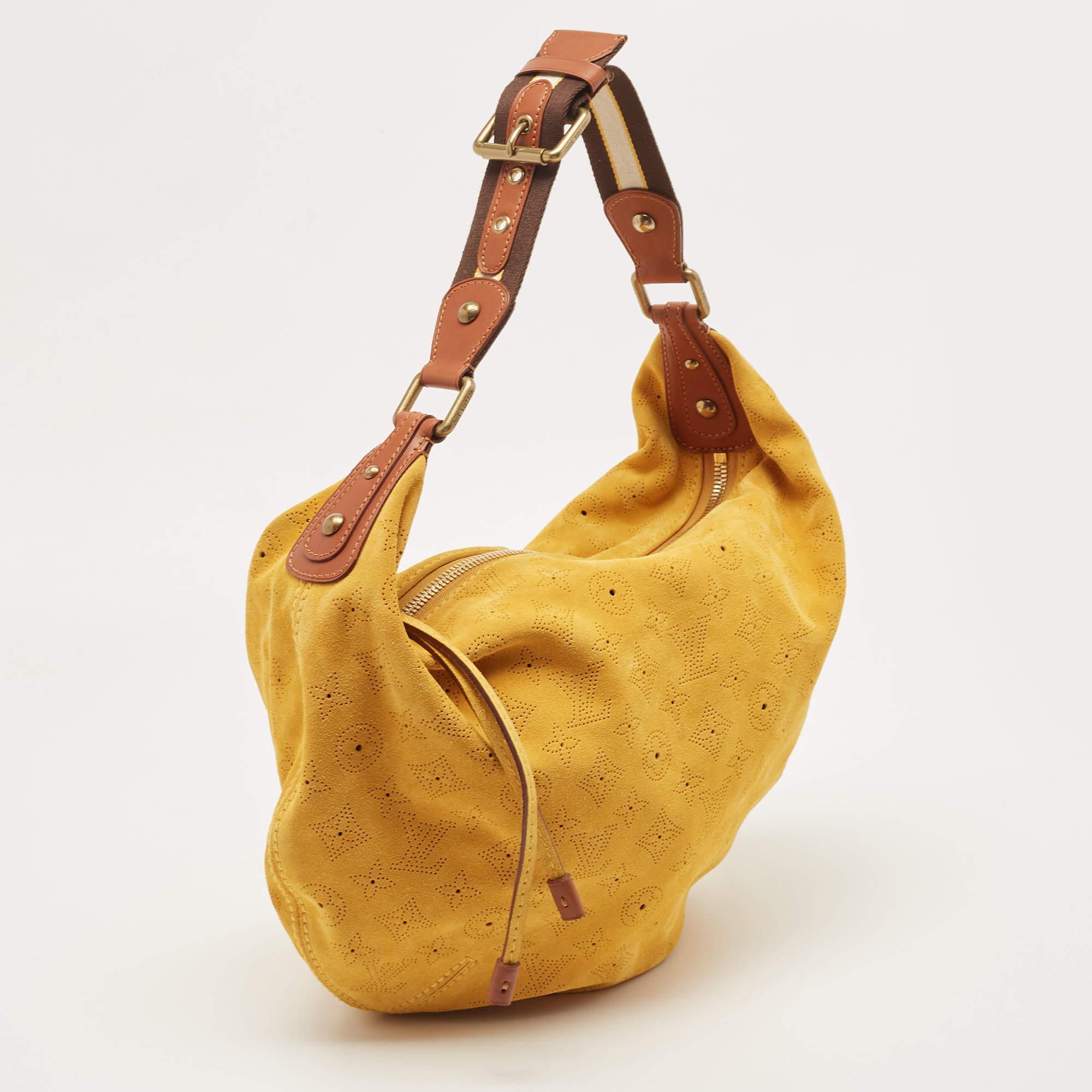 This beautifully stitched suede hobo is by Louis Vuitton. With a capacious fabric-lined interior, a comfortable handle, and a fine finish, this maize hobo is bound to offer style and practical ease.

