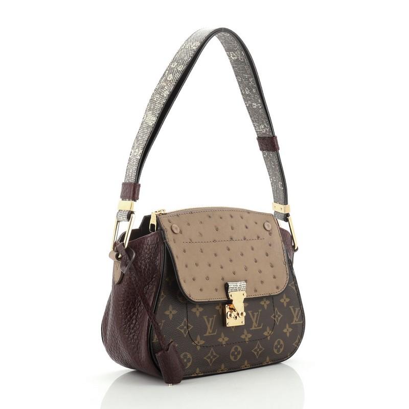 This Louis Vuitton Majestueux Shoulder Bag Monogram Canvas and Exotics, crafted from the brown monogram coated canvas, features genuine purple ostrich skin flap with grosgrain leather wings, genuine lizard skin strap, flat zipped back pocket, and
