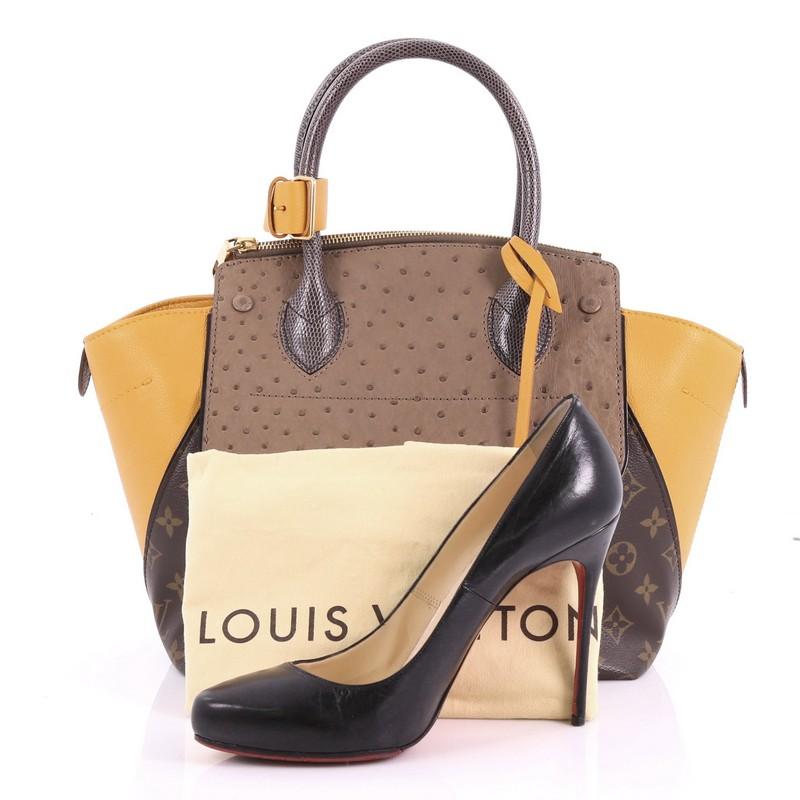 This Louis Vuitton Majestueux Tote Monogram Canvas and Exotics PM, crafted in brown monogram coated canvas, genuine taupe ostrich skin flap, abd mustard grosgrain leather wings, features an angular silhouette with dual-rolled lizard handles, a flat