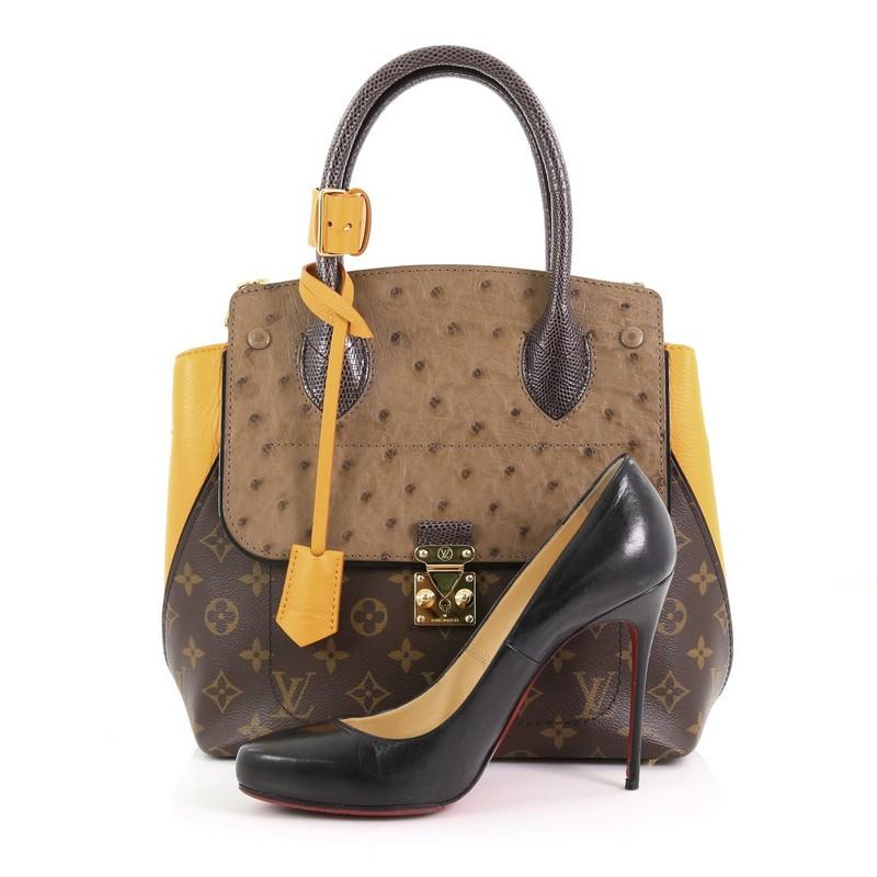 This Louis Vuitton Majestueux Tote Monogram Canvas and Exotics PM, crafted in brown monogram coated canvas, genuine ostrich skin flap, grosgrain leather wings, features an angular silhouette, dual rolled genuine lizard handles, protective base