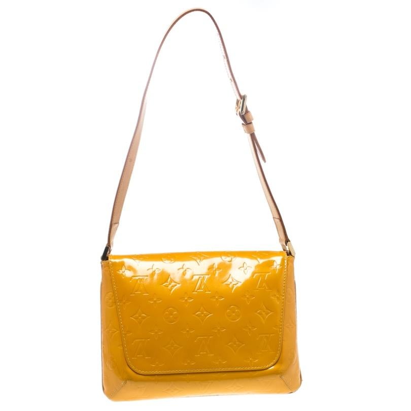 Carry this beauty in your hands or on your shoulder with the adjustable strap made of leather. This Louis Vuitton Thompson Street is crafted in yellow Vernis patent leather. The bag has a top flap and opens to a spacious leather interior with one