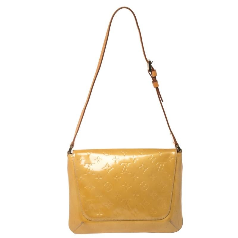 This Louis Vuitton Thompson Street Shoulder bag is elegant and practical! Crafted from classic monogram Vernis leather, this flap bag is adorned with gold-tone hardware and a leather trim. It features a comfortable beige leather shoulder strap and