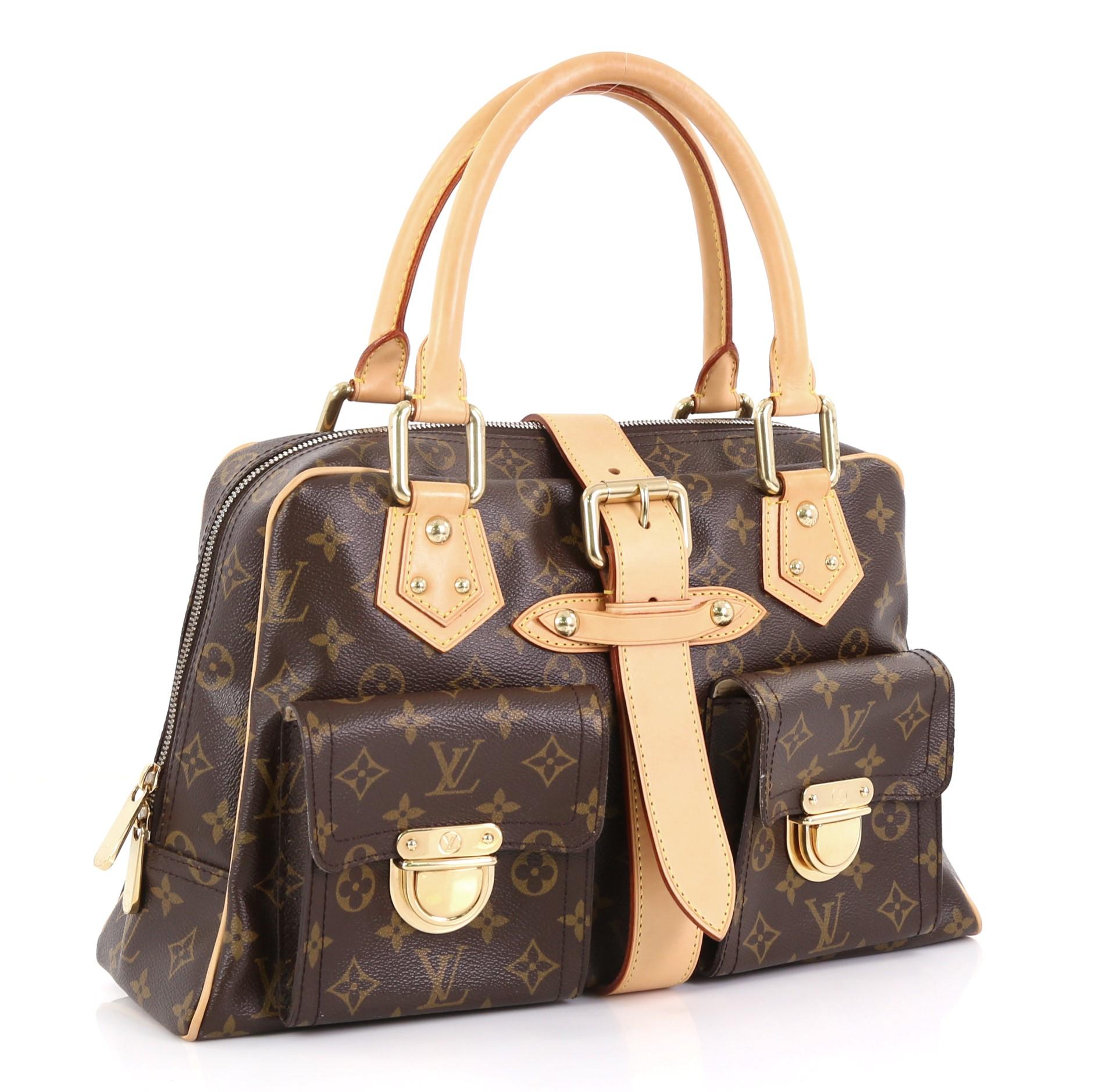 This Louis Vuitton Manhattan Handbag Monogram Canvas GM, crafted in brown monogram coated canvas, features dual rolled vachetta leather handles, front pockets with push-lock closure, and gold-tone hardware. Its top zip closure opens to a beige