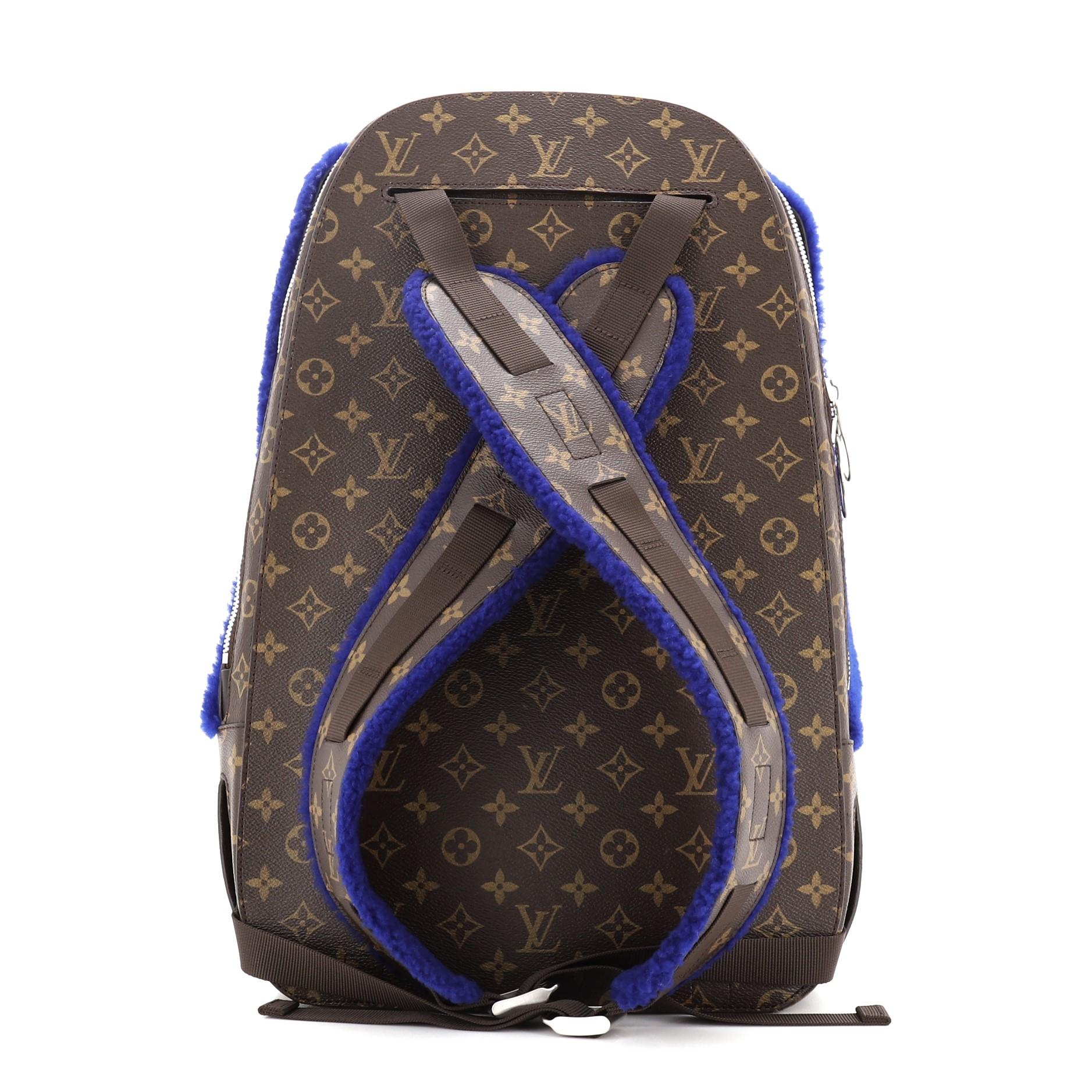 Louis Vuitton Marc Newson Backpack Shearling and Monogram Canvas with blue fur, silver-tone hardware and alcantara microfiber lining. Dual zip backpack, front zip with one interior slip pocket and one mesh interior pocket. Back zip with one mesh