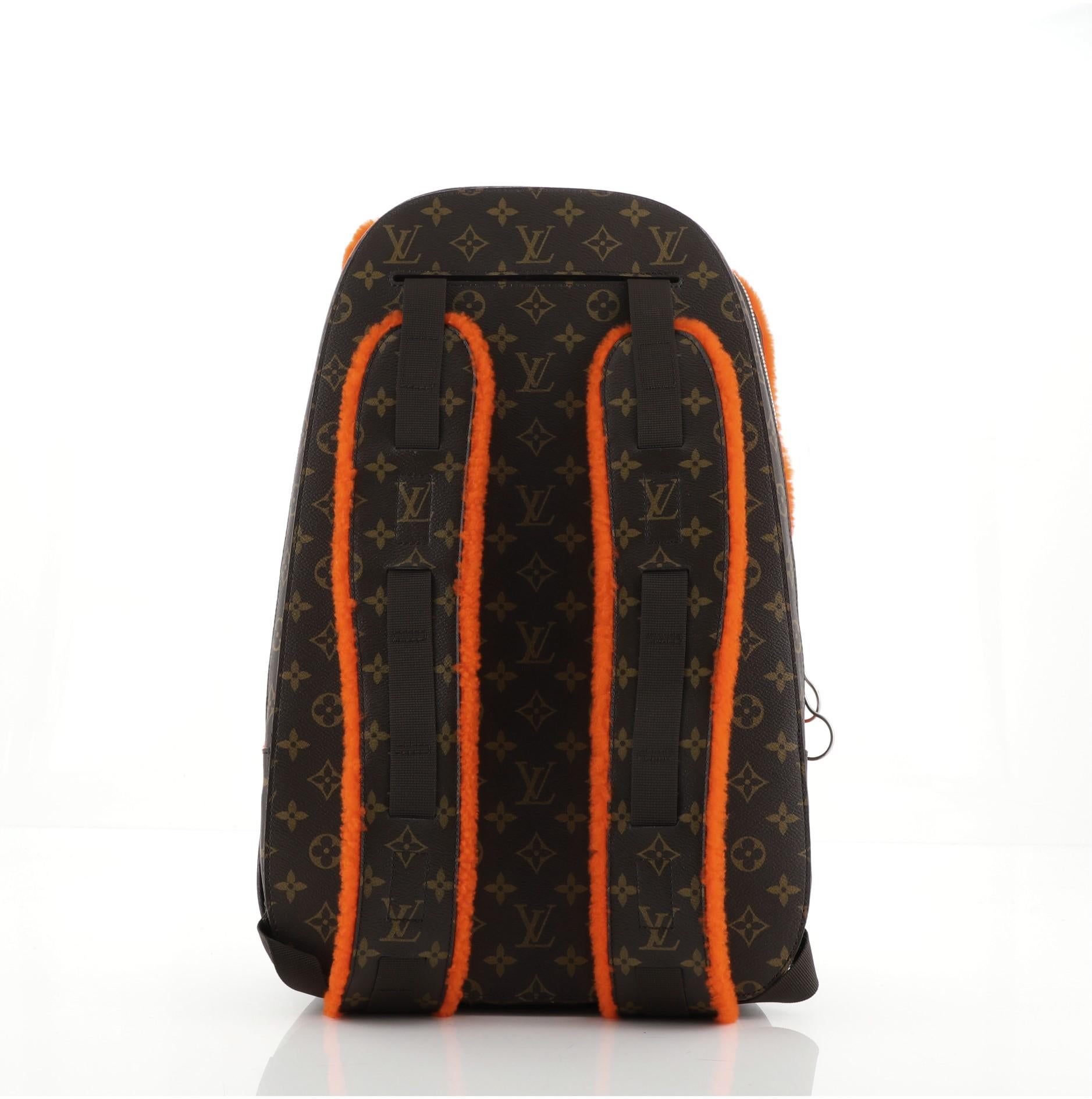 Louis Vuitton Marc Newson Backpack Shearling and Monogram Canvas with orange fur, silver-tone hardware and Alcantara microfiber lining. Dual zip backpack, front zip with one interior slip pocket and one mesh interior pocket. Back zip with one mesh