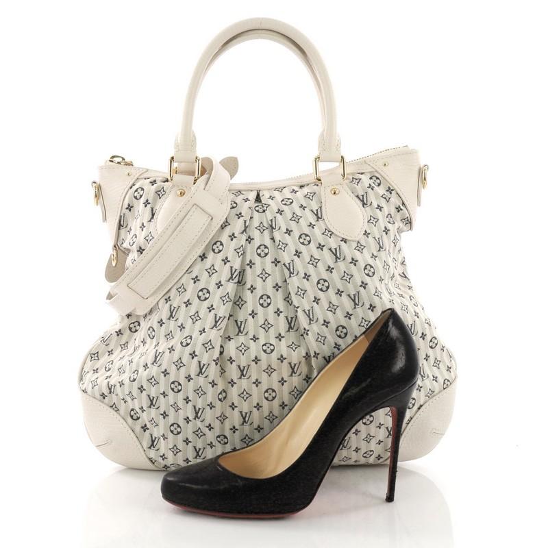 This Louis Vuitton Marina Handbag Mini Lin Croisette PM, crafted in off white mini lin canvas, features dual rolled leather handles, pleated silhouette, and gold-tone hardware. Its zip closure opens to a beige fabric interior with slip pocket.
