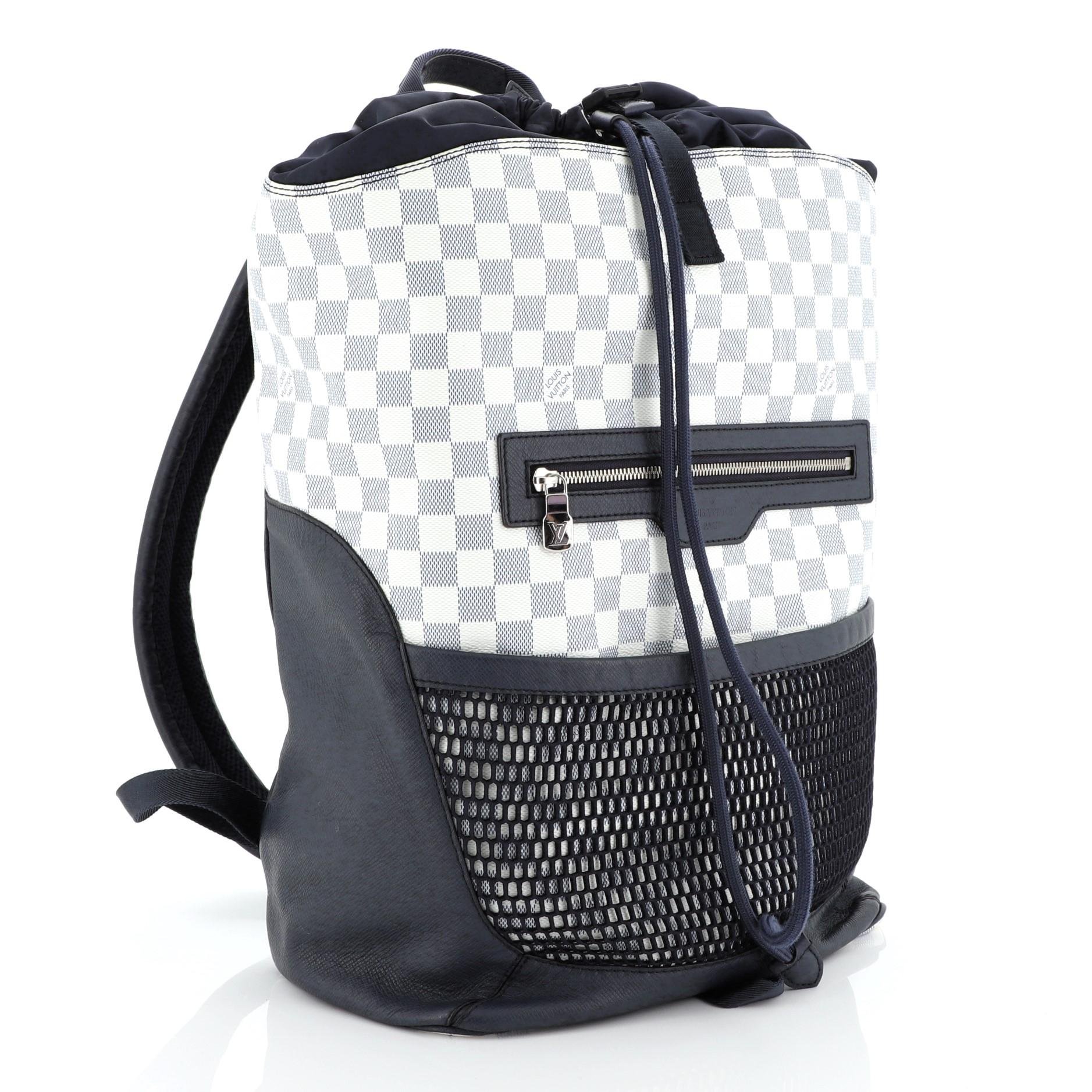 This Louis Vuitton Matchpoint Backpack Damier Coastline, crafted in damie azur coated canvas and blue leather and nylon, features a top handle, backpack straps, exterior front zip pocket, front mesh pocket and silver-tone hardware. It opens to a