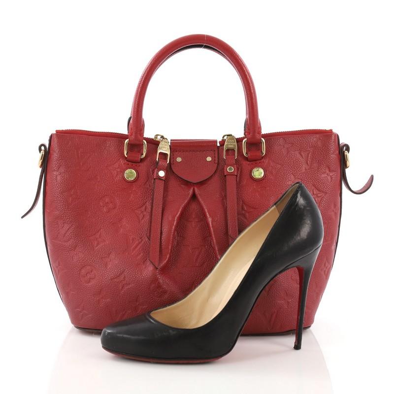 This Louis Vuitton Mazarine Handbag Monogram Empreinte Leather PM, crafted from red monogram empreinte leather, features dual rolled leather handles, pleated silhouette, protective base studs, and gold-tone hardware. Its two-way zip closure with