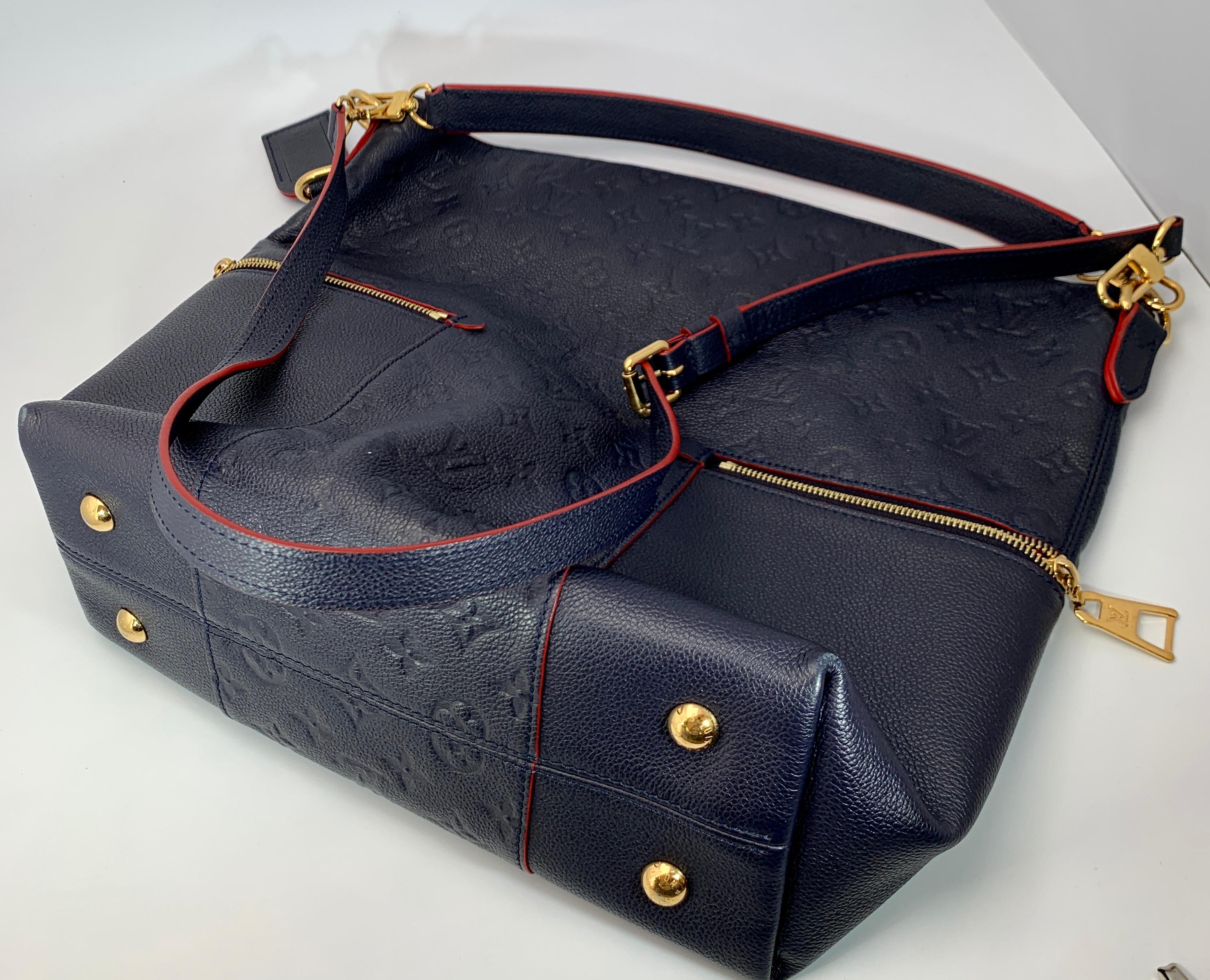 
Louis Vuitton Melie Navy Leather Empreinte Hobo Bag ,Monogram Leather
Very eye catching LV Mélie  Monogram Empreinte Leather. 
Navy blue color with red lining and interior
The shoulder bag features horizontal zipper pockets that wrap around the
