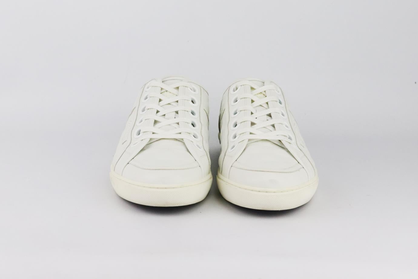 These low-profile sneakers by Louis Vuitton are made from soft white leather with brand’s iconic embossed detail on the sides. Heel measures approximately 25 mm/ 1 inches. White leather. Lace fastening at front. Does not come with box or dustbag.