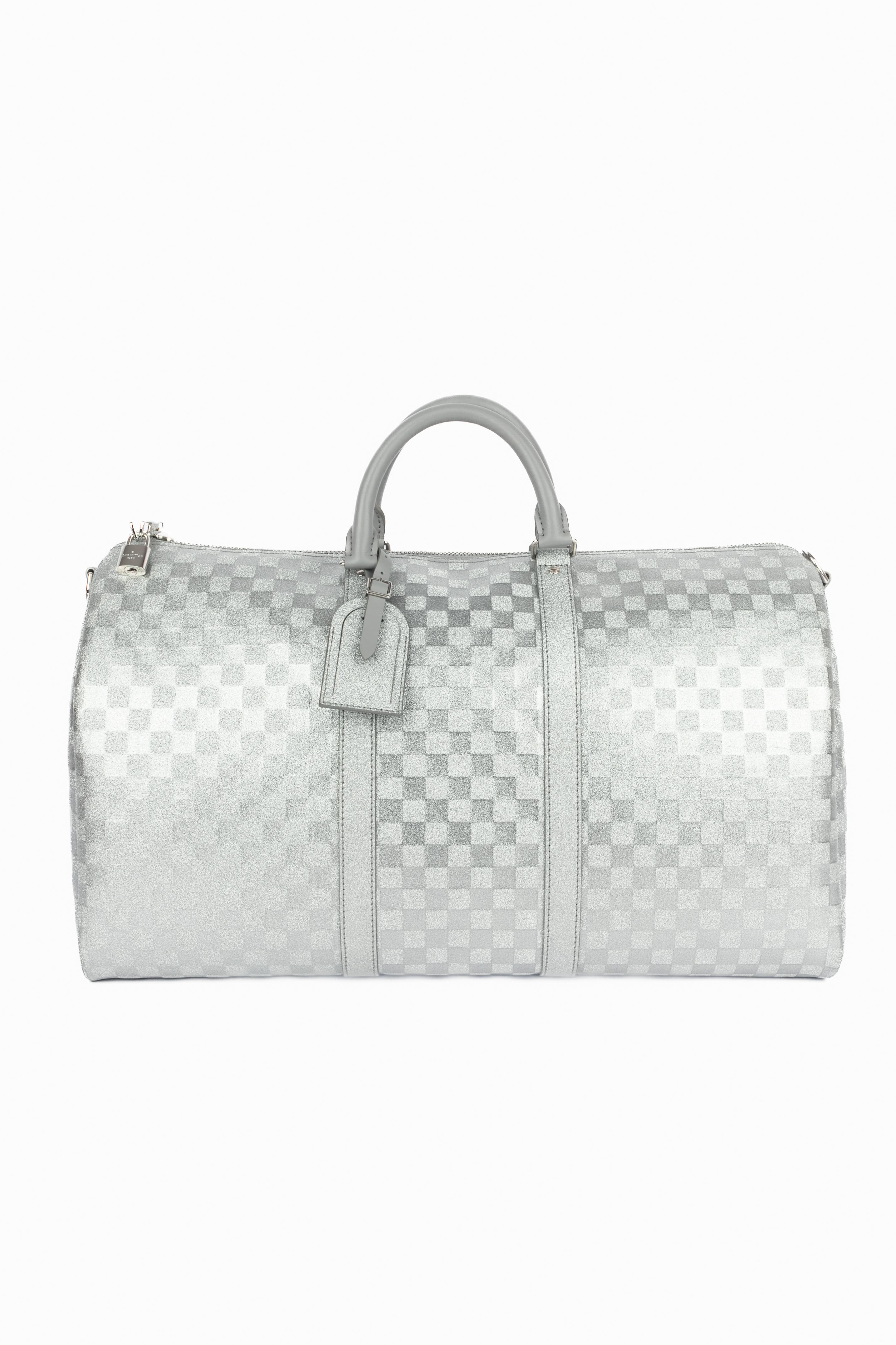 LOUIS VUITTON - (Made in France) Crossbody calfskin Keepall bag with silvery-glitter checked pattern with a two-slider zipper. Double handle and an adjustable removable crossbody strap. 2022 Spring-Summer menswear Collection under the artistic