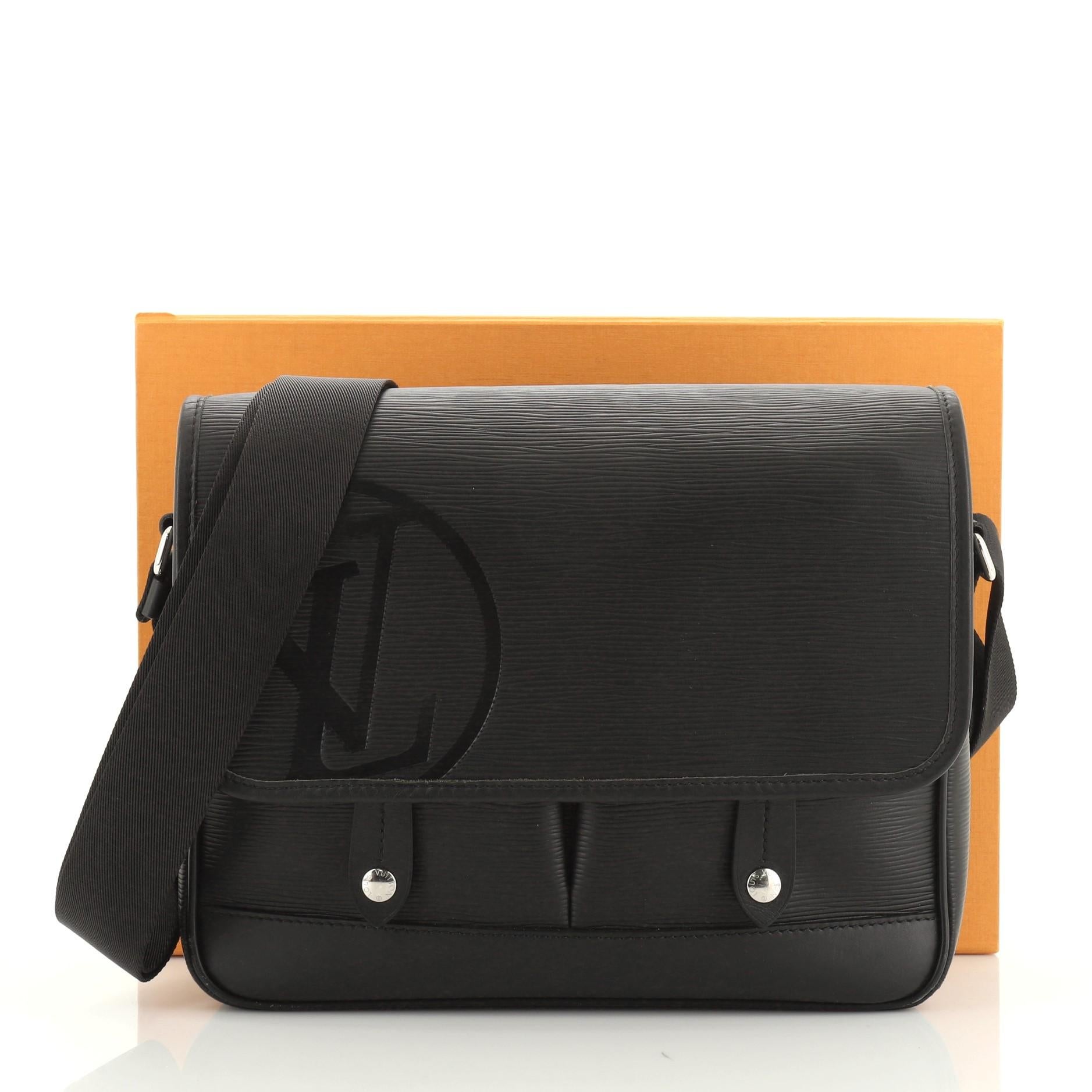 This Louis Vuitton Messenger Bag Initials Epi Leather PM, crafted from black epi leather features an adjustable strap, slip pockets under flap, and silver-tone hardware. Its flap opens to a blue microfiber interior with slip pocket. Authenticity