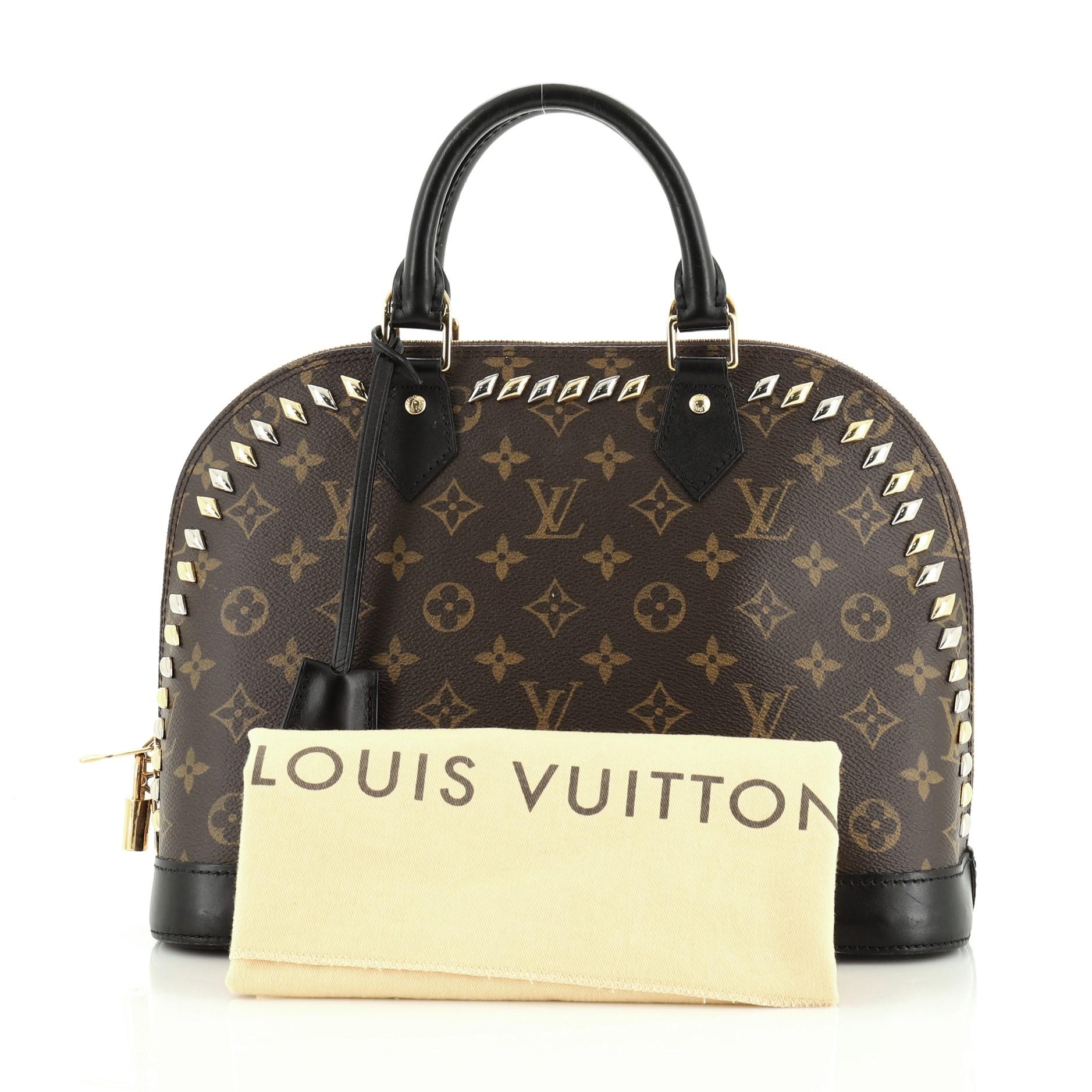 This Louis Vuitton Metal Stones Alma Handbag Studded Monogram Canvas PM, crafted from brown monogram coated canvas, features dual rolled handles, multiple studs, and silver and gold-tone hardware. Its zip closure opens to a brown fabric interior