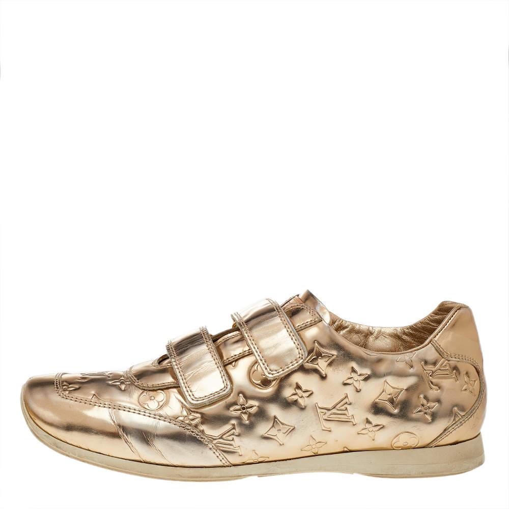 These Tennis shoes from Louis Vuitton are here to elevate your style and let you explore new dimensions in the latest trends. These shoes are created skillfully using the Monogram gold metallic leather with dual velcro-strap closures adorning the