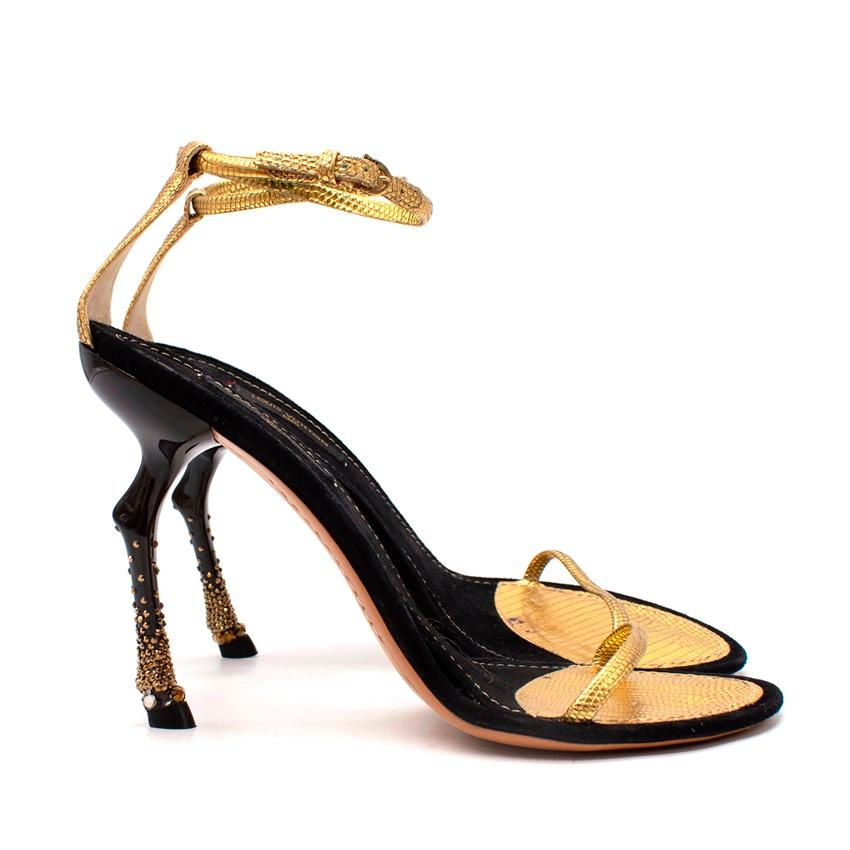 Louis Vuitton Metallic Gold Sandals with Horse Leg Stiletto Heel
 

 - Unusual sandal featuring a stiletto heel in the shape of a horse's leg, complete with bejeweled hoof and sculpted knee joint
 - Black suede footbed, with delicate metallic gold,