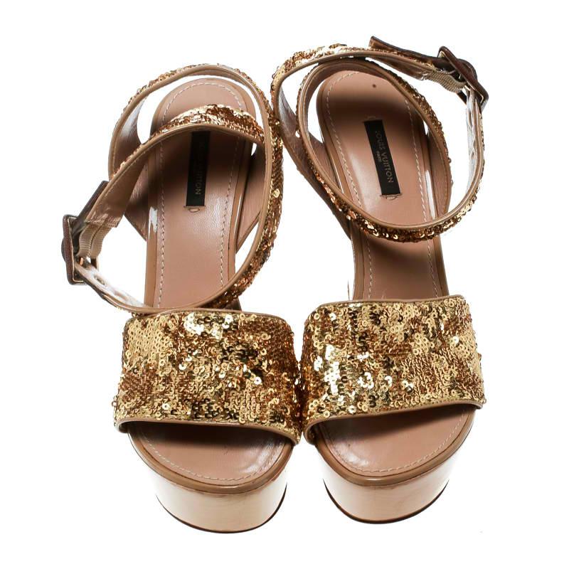 Bold and beautiful, these Louis Vuitton sandals are all you need to shine brighter than the sun! These metallic gold sandals are crafted from sequins and patent leather and feature an open toe silhouette. They flaunt wide vamp straps and buckled