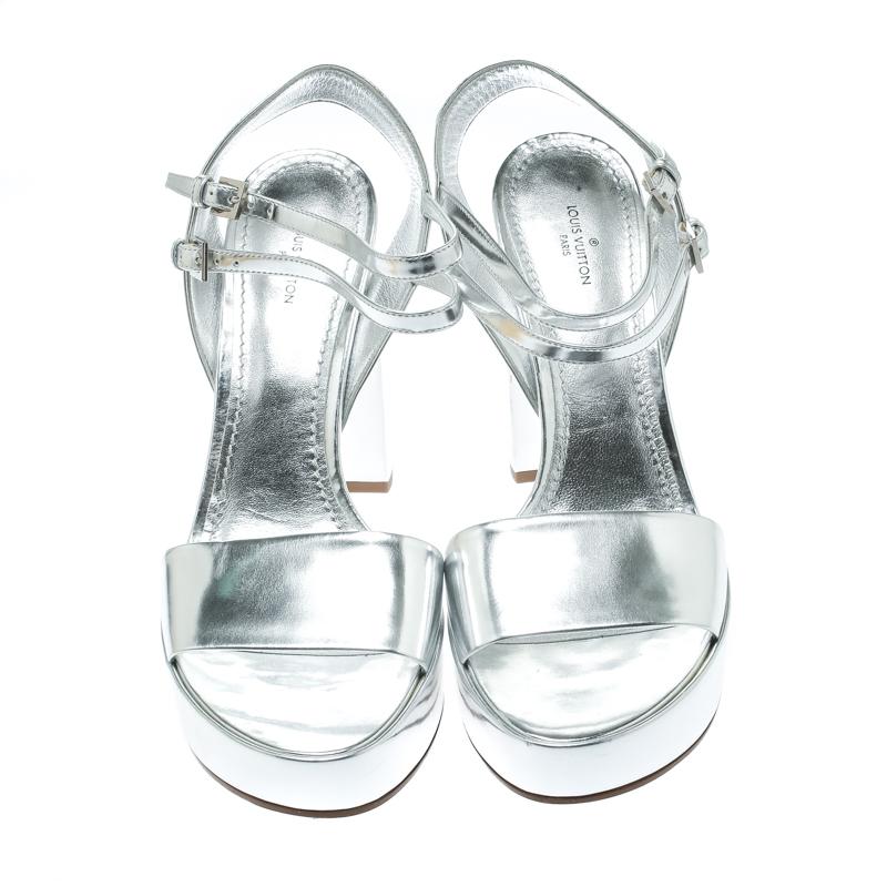 Shimmering, scintillating and oh so lovely, these sandals from Louis Vuitton are love at first sight! These metallic silver sandals are crafted from patent leather and feature an open toe silhouette. They flaunt a single vamp strap and come equipped