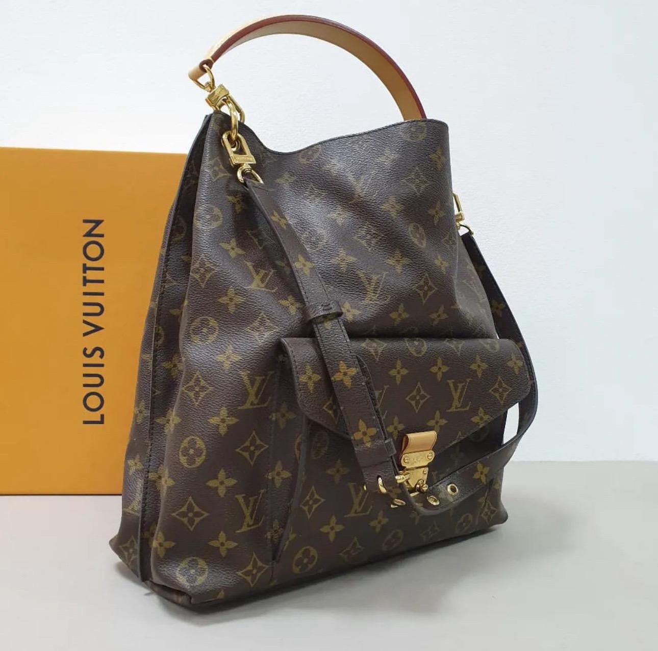     This Metis bag is a reinterpretation of the LV Monceau briefcase and is crafted from signature monogram canvas. The bag features a single top handle, a detachable shoulder strap, protective metal feet, and a front pocket with a push-lock