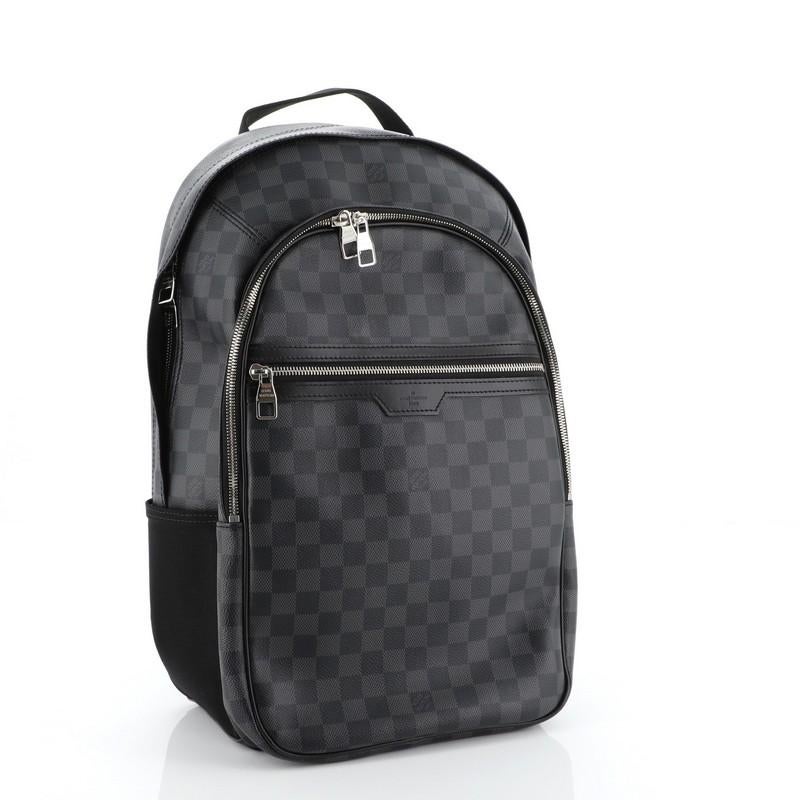 This Louis Vuitton Michael Backpack Damier Graphite, crafted from damier graphite coated canvas, features a short leather handle, canvas padded backpack straps, leather trim, exterior front zip pockets, and silver-tone hardware. Its two-way zip