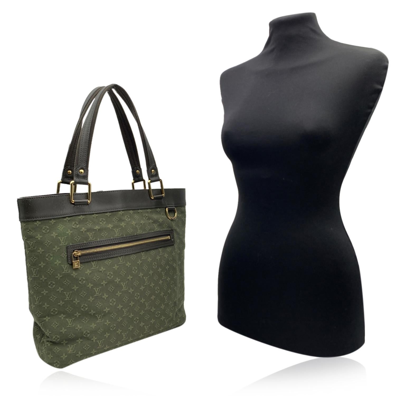 Khaki Mini Lin Monogram canvas 'Lucille GM' by LOUIS VUITTON. Can be carried on the shoulder or on the arm. Open top. 1 front zip pocket. Brown leather trim and handles and gold metal hardware. Fabric lining. 3 main sections inside. 1 side zip