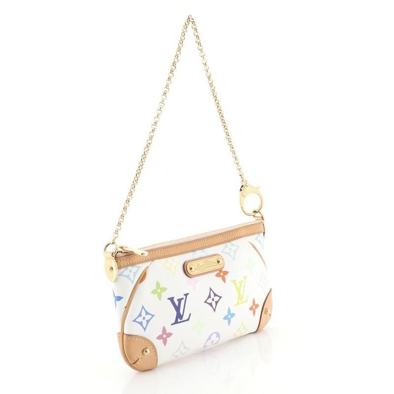 This Louis Vuitton Milla Pochette Monogram Multicolor MM, crafted from white monogram multicolor coated canvas, features natural vachetta leather trim, short chain strap and gold-tone hardware. Its zip closure opens to a red microfiber interior with