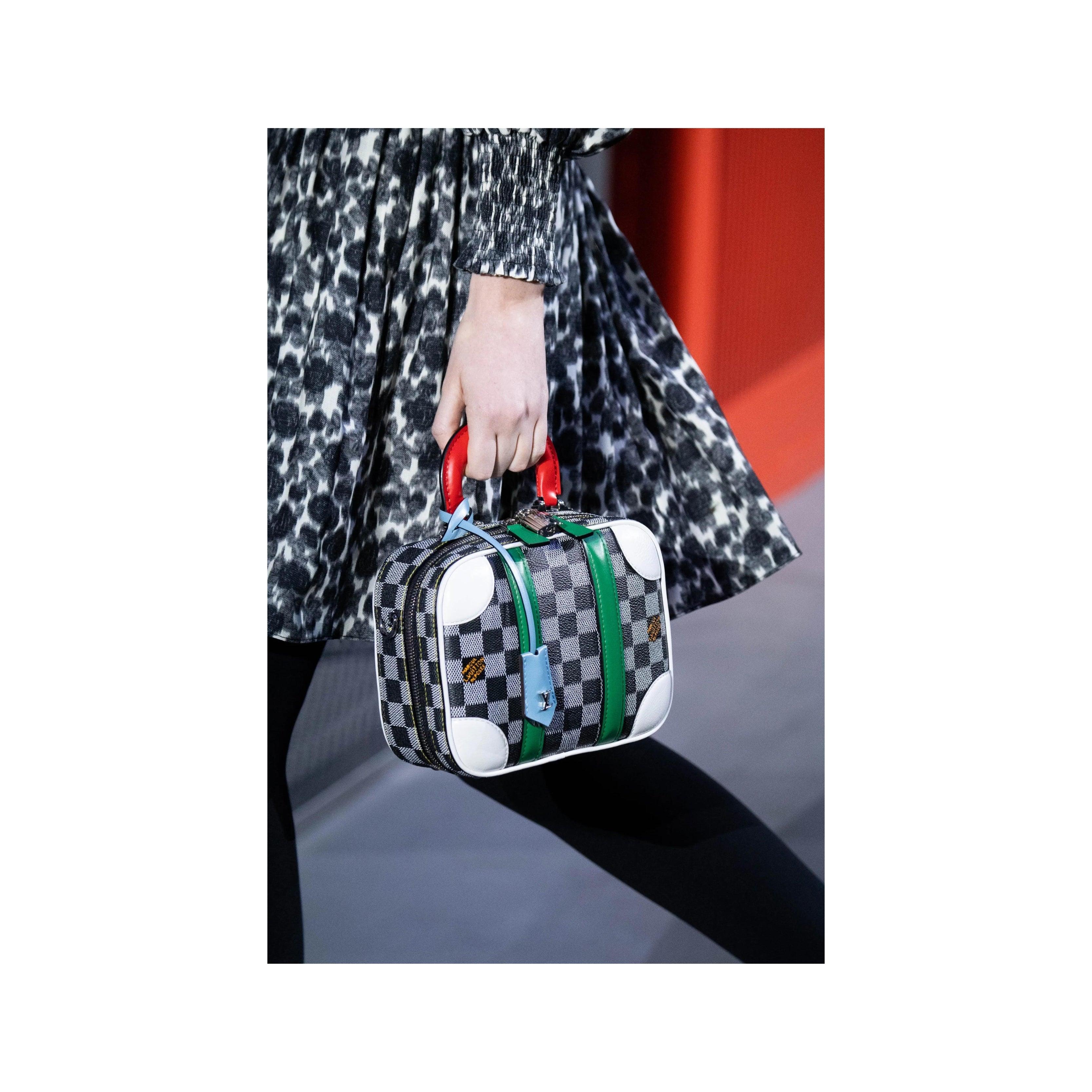 Introducing the Louis Vuitton Mini Luggage Damier BB Handbag by Nicolas Ghesquière's from the Fall-Winter 2019 collection. Crafted with LV's iconic Epi leather in a classic black and white Damier print. The pop of color from the red handle and green