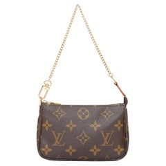Pochette Mini Pochette Accessoires de LOUIS VUITTON, en toile Monogram marron, avec chaîne