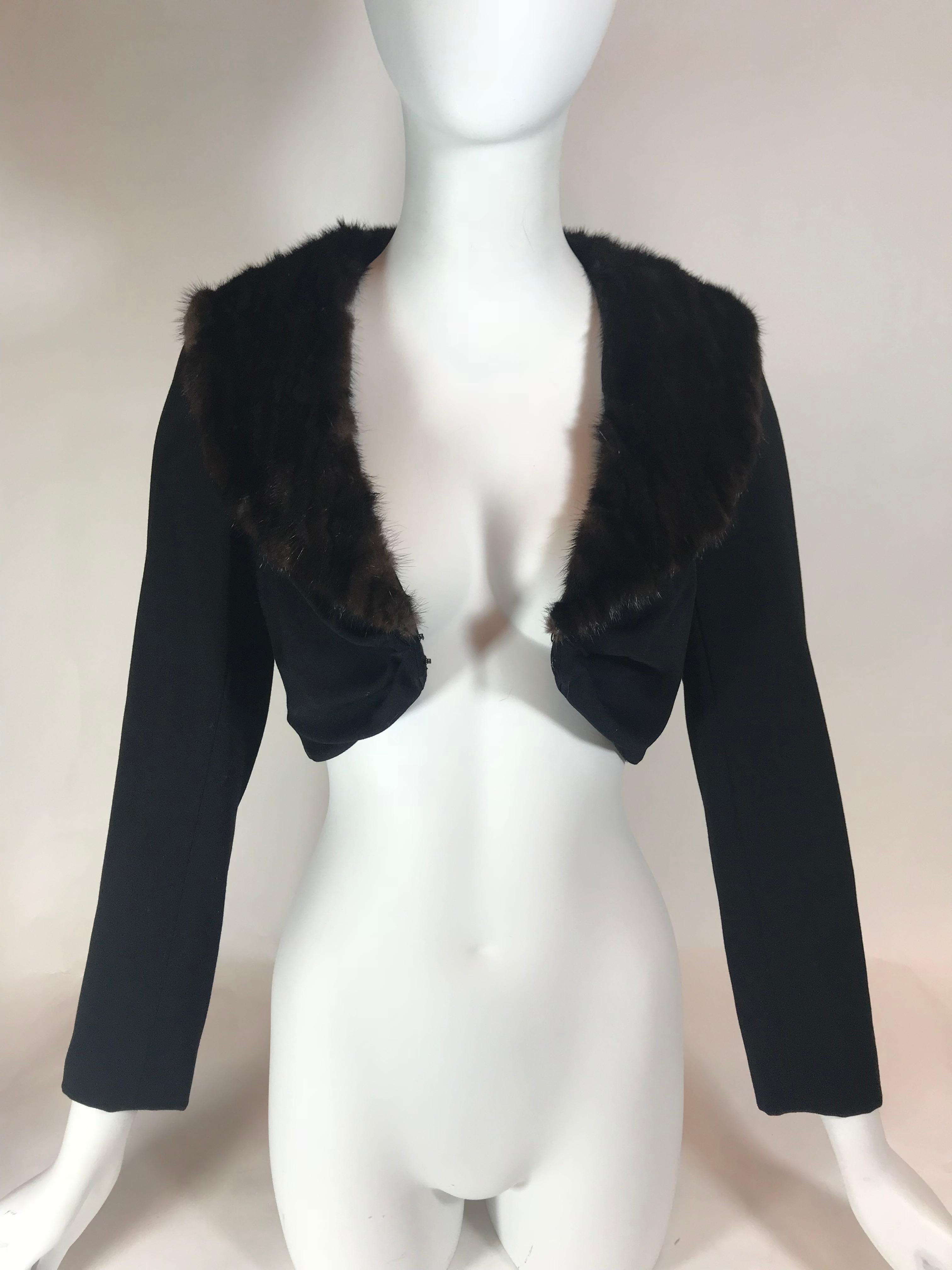 Black wool and silk. Brown mink collar. Hook and eye closure at front. Extra cropped. 