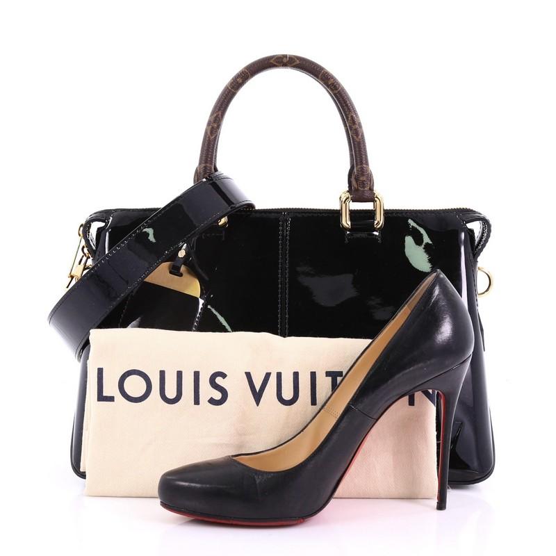 This Louis Vuitton Miroir Handbag Vernis with Monogram Canvas, crafted in black vernis leather, features dual rolled monogram handles and strap and gold-tone hardware. Its zip closure opens to a black fabric interior with slip pockets. Authenticity