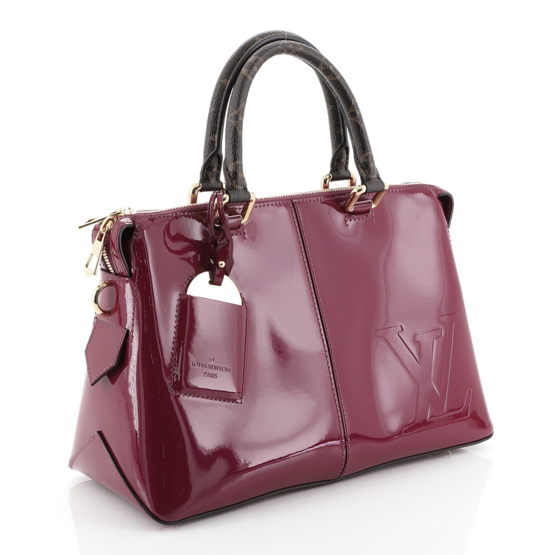 This Louis Vuitton Miroir Handbag Vernis with Monogram Canvas, crafted in purple monogram vernis, features dual rolled monogram handles and gold-tone hardware. Its zip closure opens to a purple fabric and coated canvas interior with slip pockets.