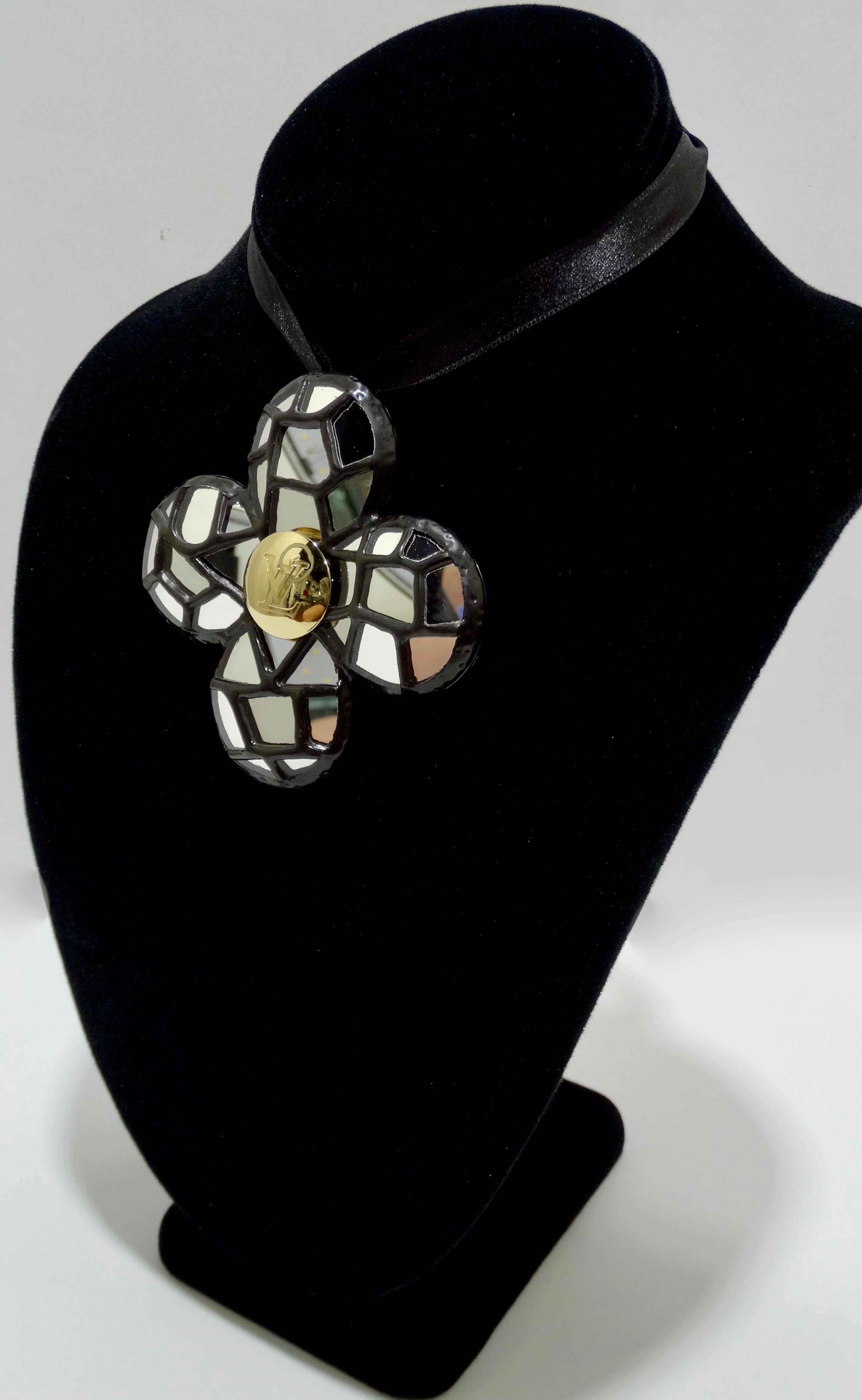 Elevate your whole look with this amazing Louis Vuitton brooch/pendant! Circa 21st Century, this steel quatrefoil brooch/pendant features a mirrored mosaic front with a gold plated LV stamped emblem in the center. The back includes a brooch closure