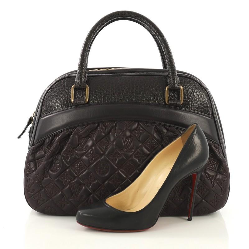 This Louis Vuitton Mizi Vienna Handbag Monogram Quilted Lambskin, crafted from brown and purple monogram quilted lambskin, features dual rolled handles, an exterior flat pocket, protective base studs, and aged gold-tone hardware. Its all-around zip