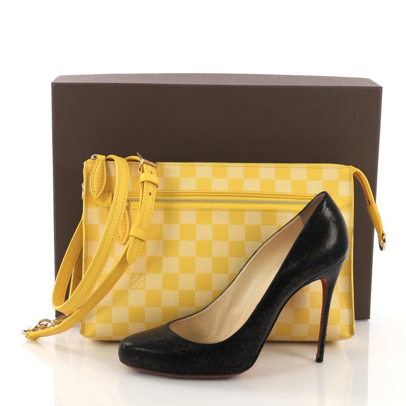 This Louis Vuitton Modul Handbag Damier Couleurs, crafted in yellow damier Couleurs, features a leather cross body shoulder strap with a frontal zip pocket and gold-tone hardware. Its top zip closure opens to a matching yellow fabric interior with