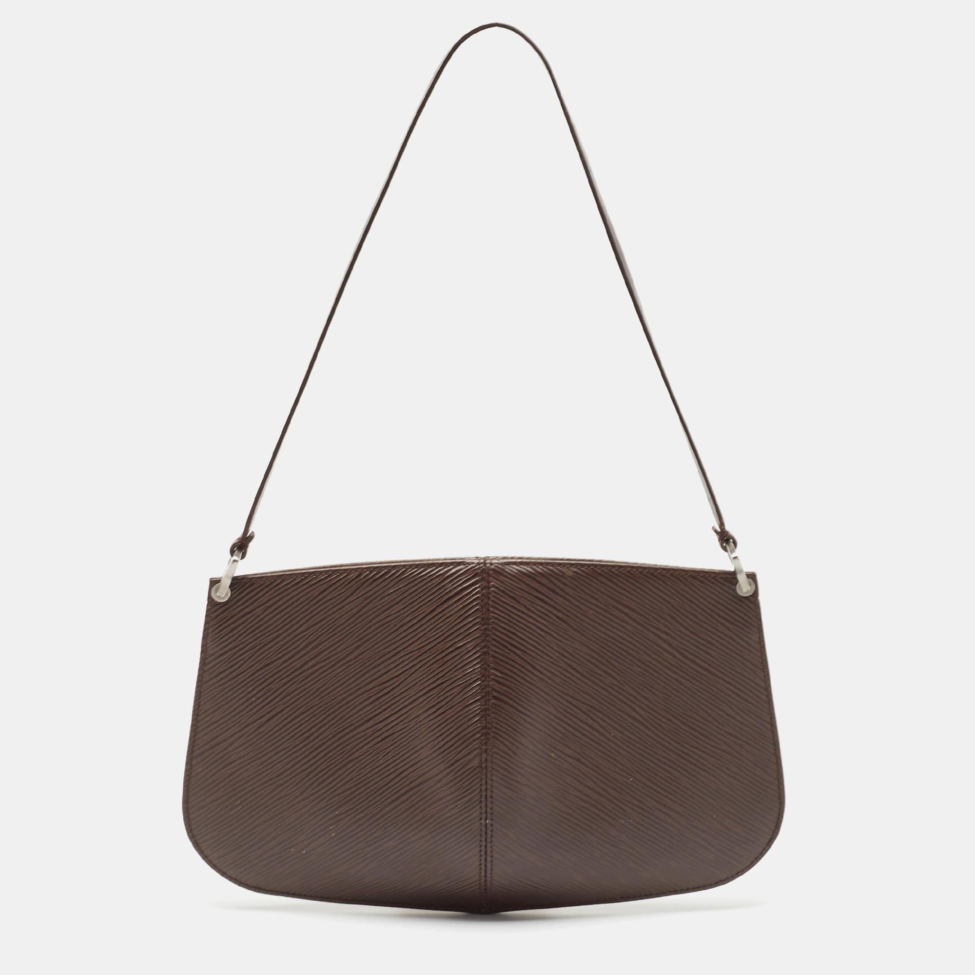 Simple yet stylish, this Demi Lune pochette bag is by Louis Vuitton. Crafted from their Epi leather in a Moka shade, the bag is held by a single handle. It is perfect for everyday use.

