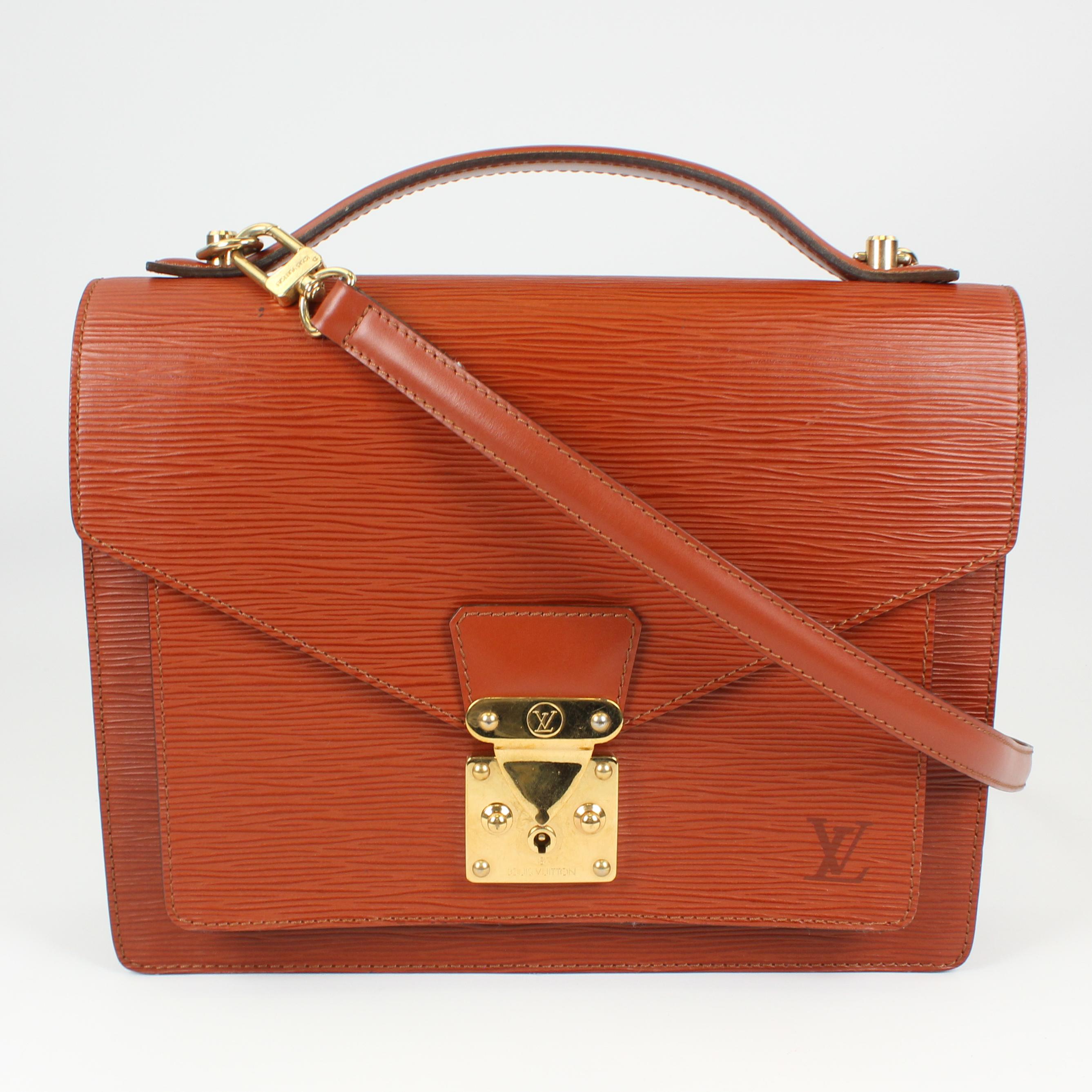This is a rare and hard to find LV bag that is coveted by many fashionistas. The Louis Vuitton epi leather Monceau briefcase bag features an elegant structured design conceived as a small briefcase. It also has an S-lock closure and a shoulder