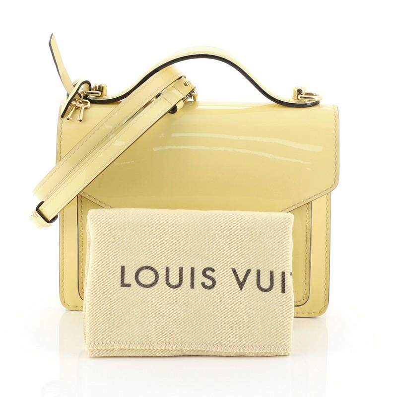 This Louis Vuitton Monceau Handbag Vernis BB, crafted from yellow vernis, features leather top handle, gusseted pocket under flap, and gold-tone hardware. Its S-lock closure opens to a yellow microfiber interior with zip pocket. Authenticity code